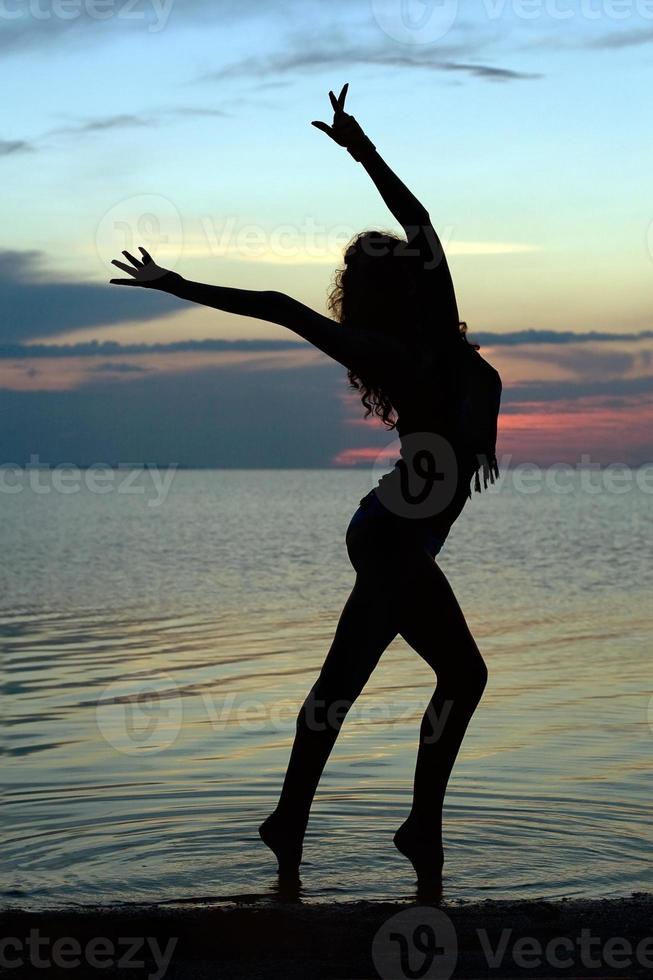 Silhouette of a sexy young woman photo