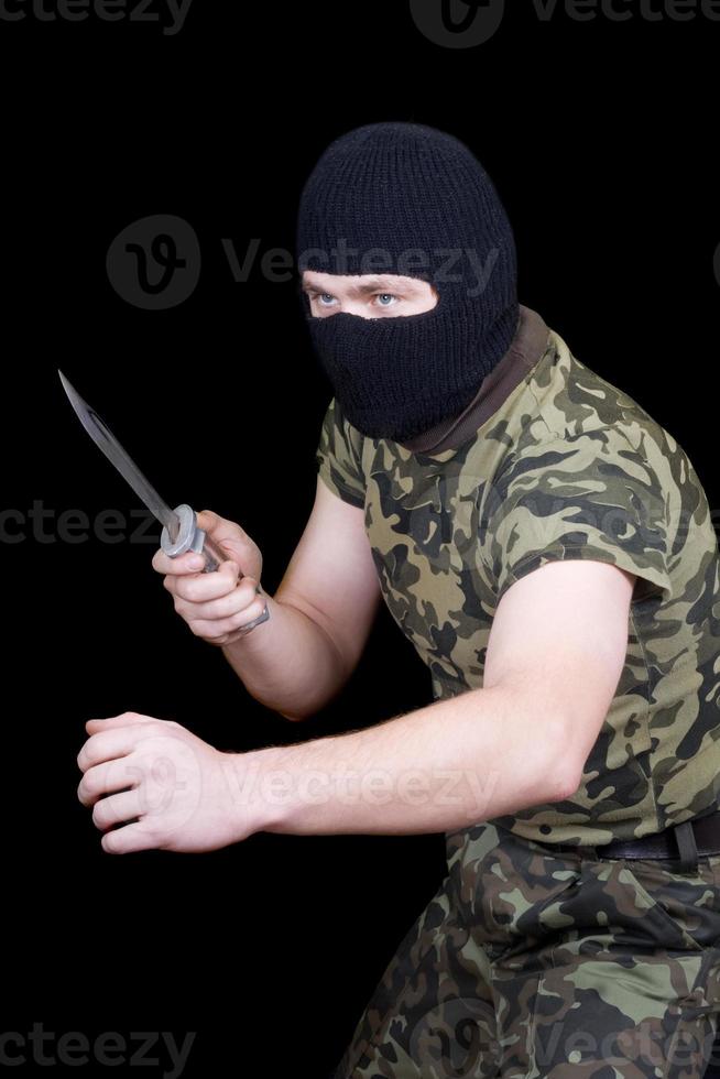 The man with a knife in a black mask photo