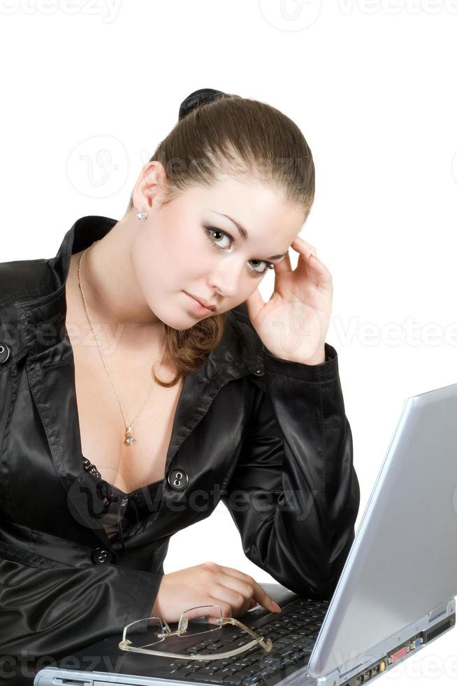 Young businesswoman works on the laptop over white photo