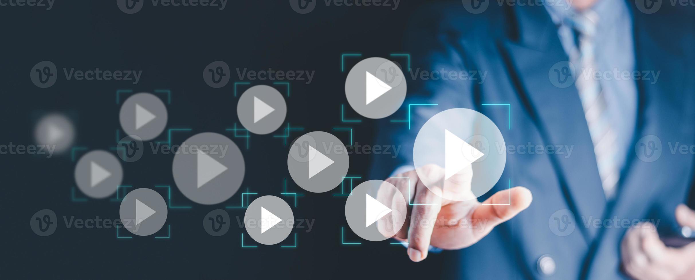 Video on demand technology with person touching play button on virtual screen to watch online VOD streaming of movie or TV . photo
