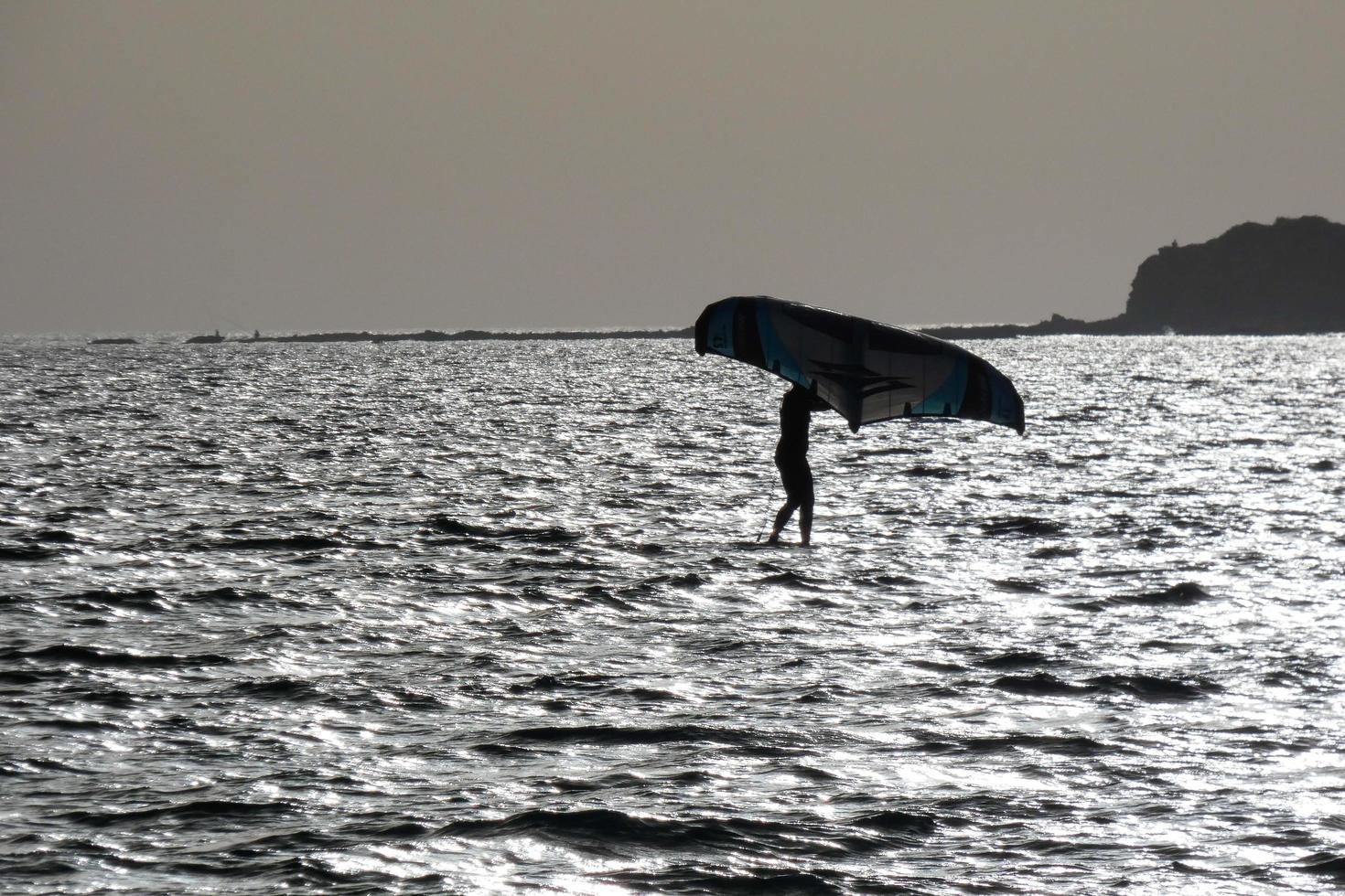 windsurfing, kitesurfing, water and wind sports powered by sails or kites photo
