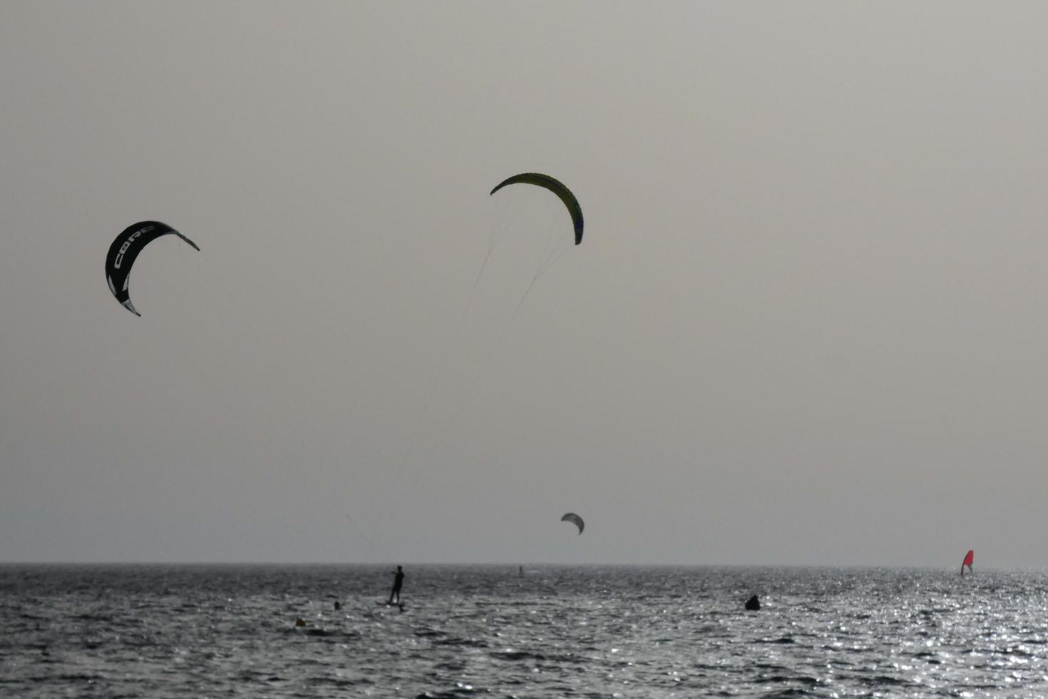 windsurfing, kitesurfing, water and wind sports powered by sails or kites photo