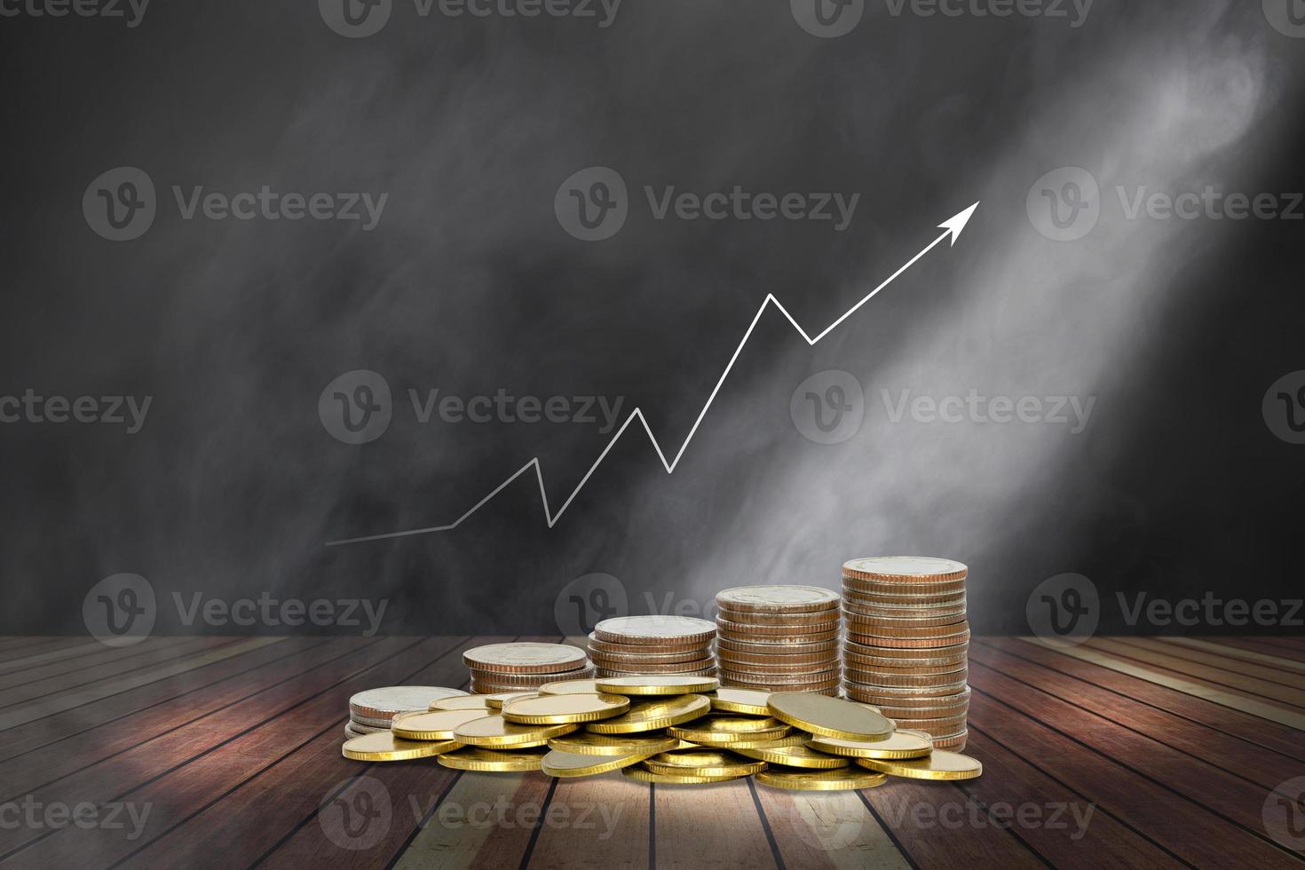 coins stack with lighting and smoke on wooden stage and chart of indicators photo