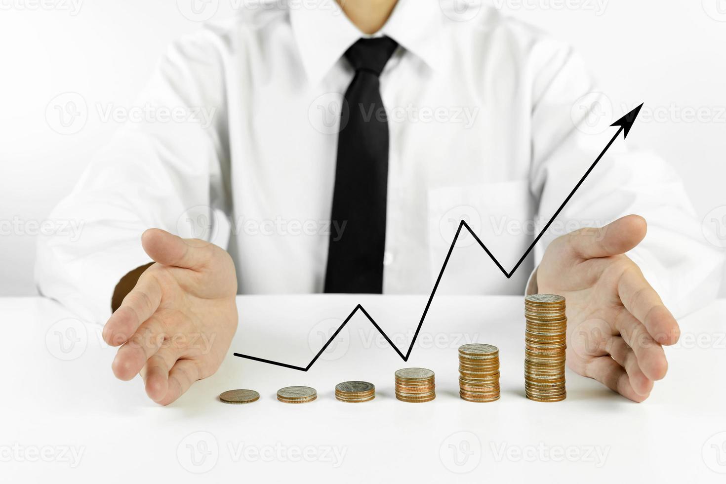 businessman hands protecting coins stacks with chart of indicators in business photo