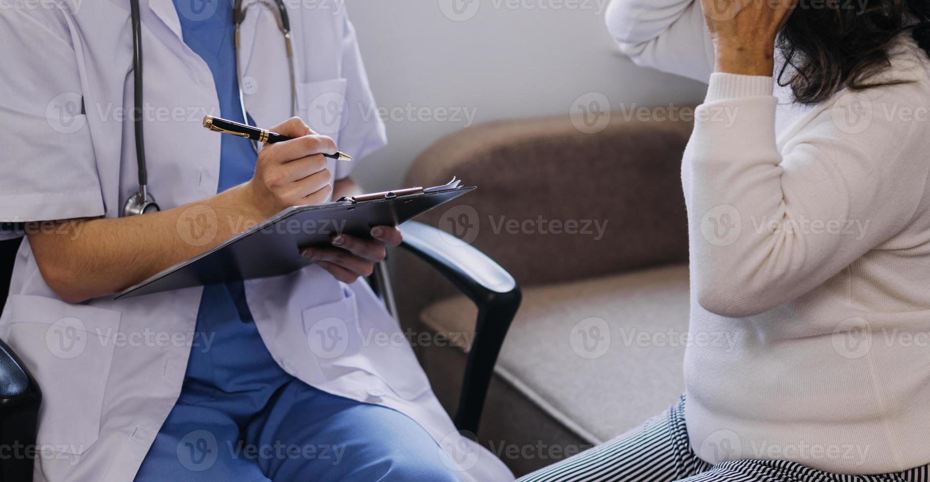 Homecare nursing service and elderly people cardiology healthcare. Close up of young hispanic female doctor nurse check mature caucasian man patient heartbeat using stethoscope during visit photo