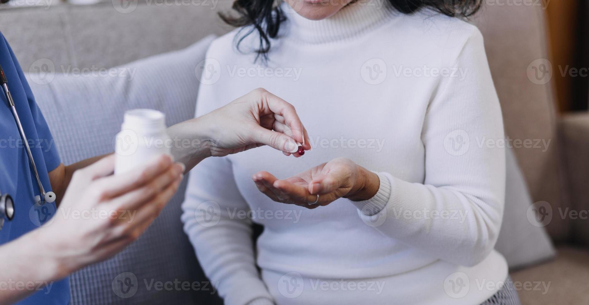 Homecare nursing service and elderly people cardiology healthcare. Close up of young hispanic female doctor nurse check mature caucasian man patient heartbeat using stethoscope during visit photo