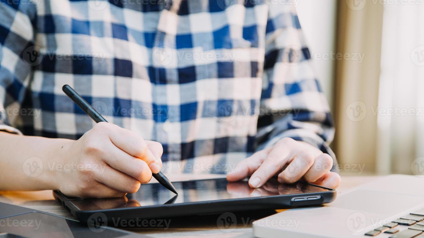 Mature businessman using a digital tablet to discuss information with a younger colleague in a modern business lounge photo