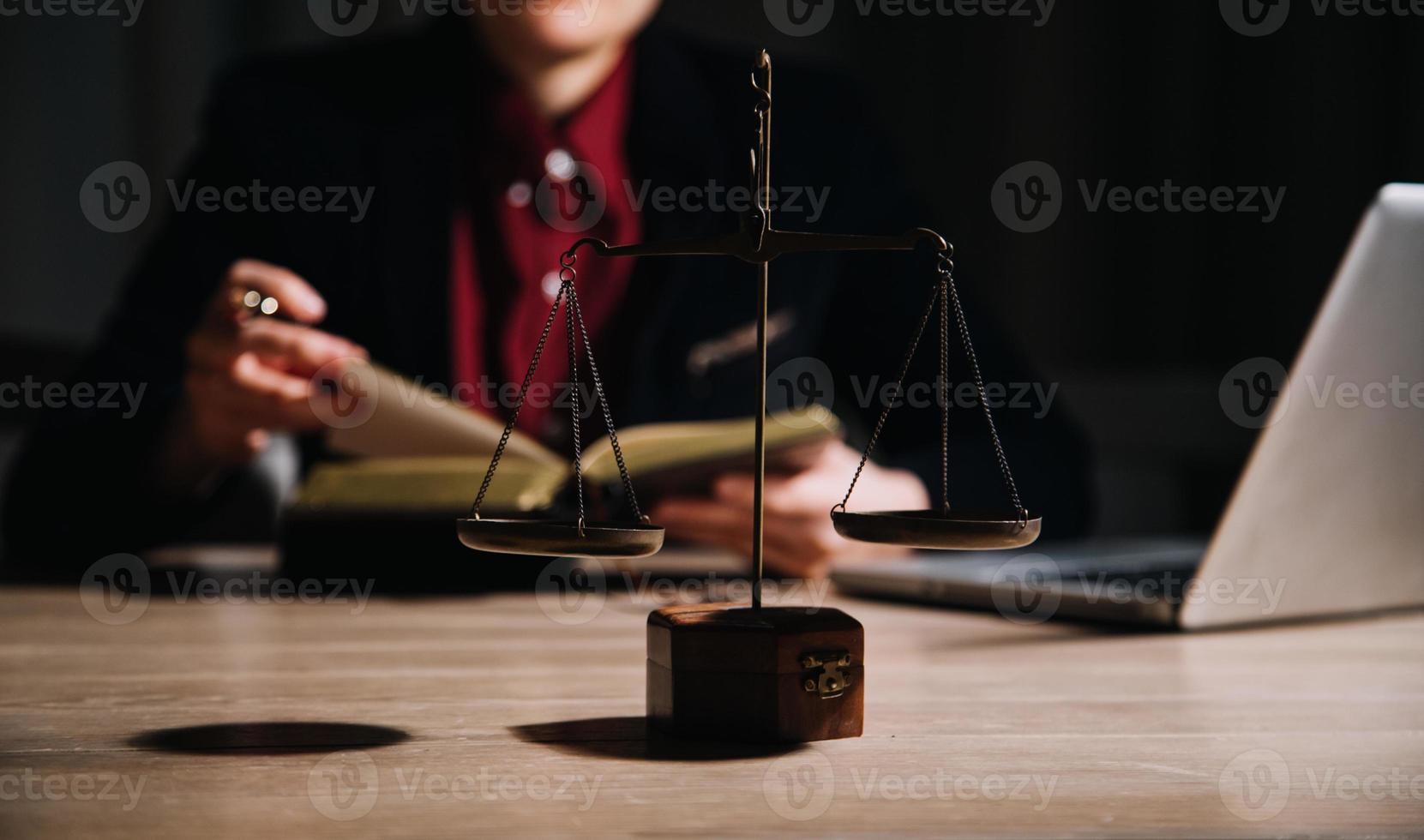 Justice and law concept.Male judge in a courtroom with the gavel, working with, computer and docking keyboard, eyeglasses, on table in morning light photo