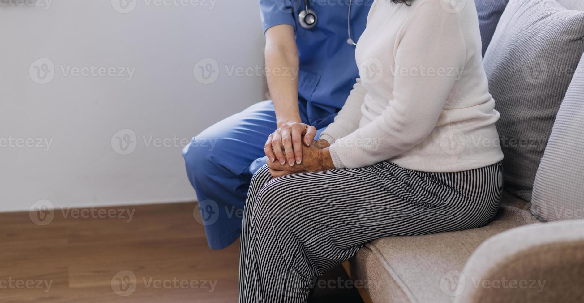 Homecare nursing service and elderly people cardiology healthcare. Close up of young hispanic female doctor nurse check mature caucasian man patient heartbeat using stethoscope during visit photo