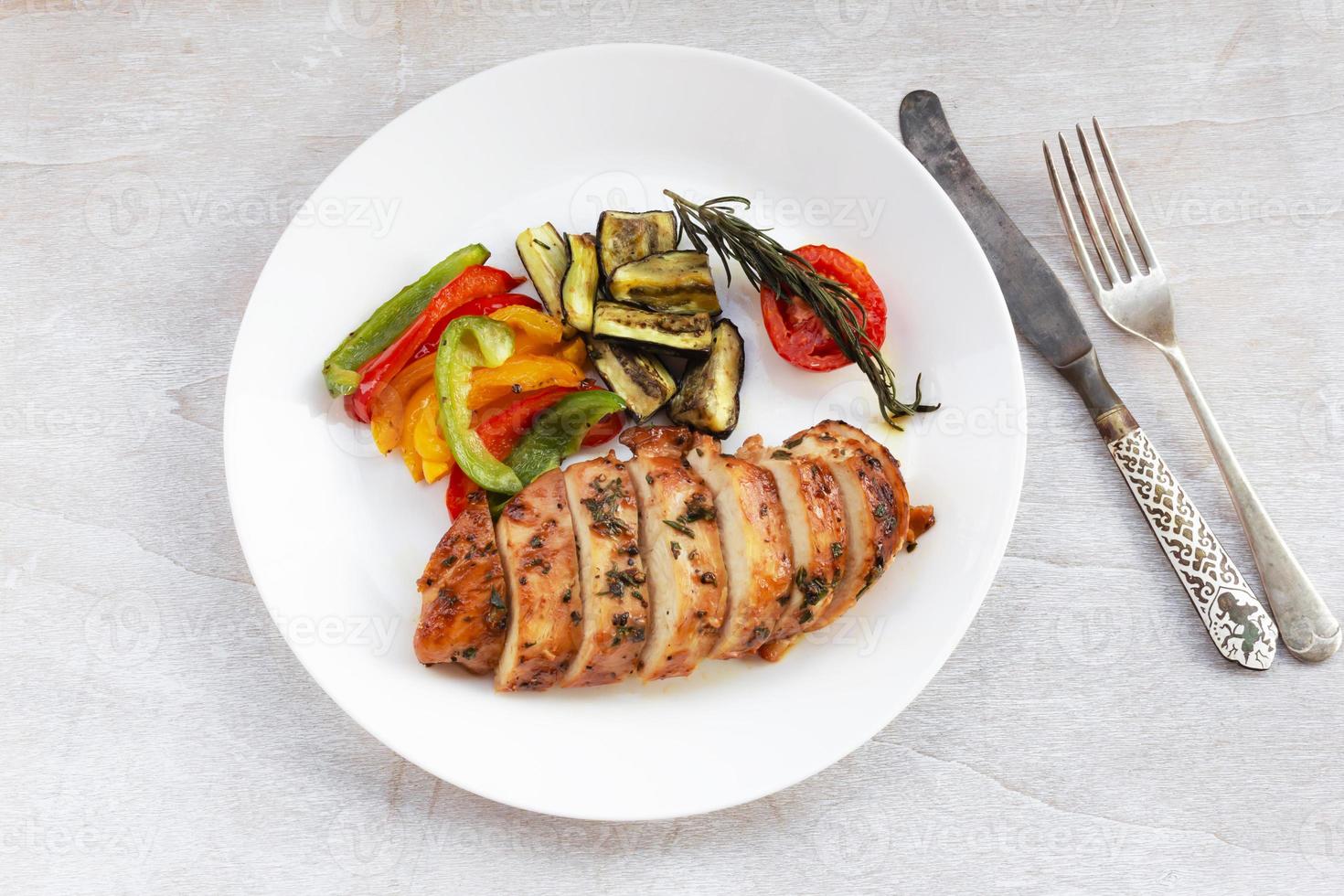 Healthy food grill chicken sweet pepper eggplant in white plate on wood background. photo