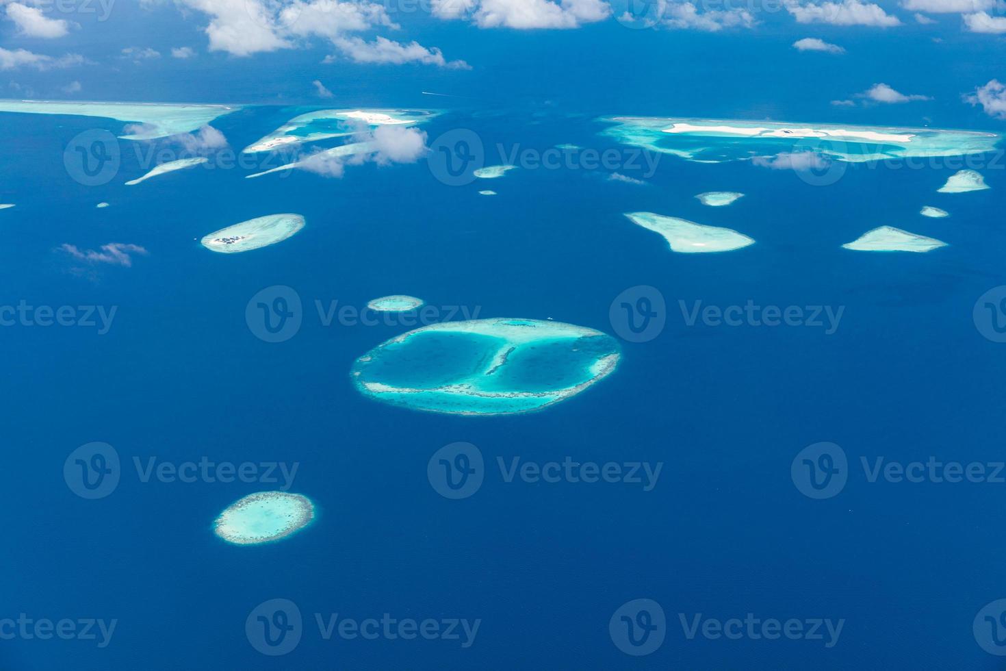 Aerial view of coral reefs in Maldives islands. Tropical aerial landscape. Luxury summer vacation and travel destination photo