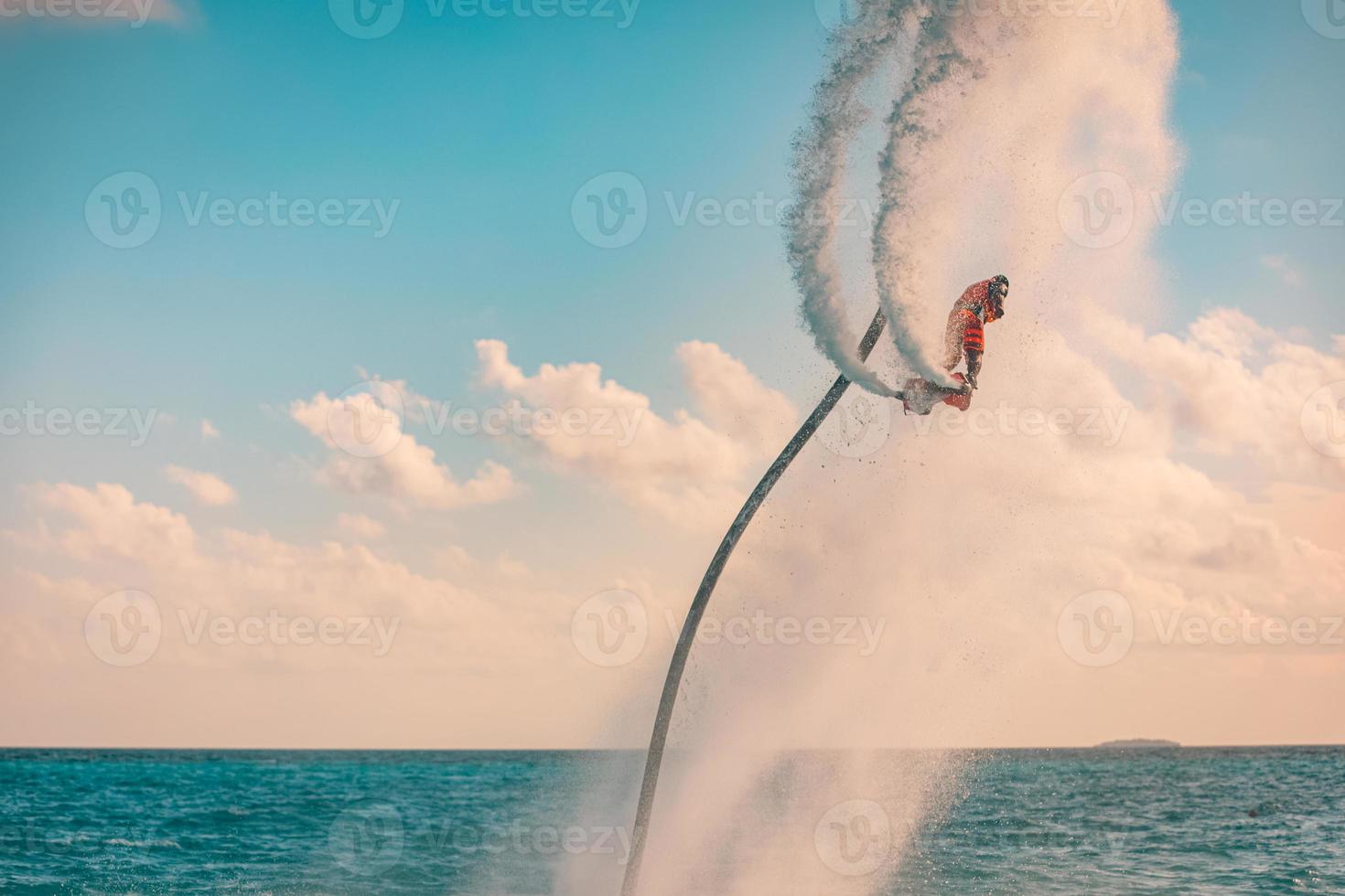 Professional pro fly board rider in tropical sea, water sports concept background. Summer vacation fun outdoor sport and recreation photo