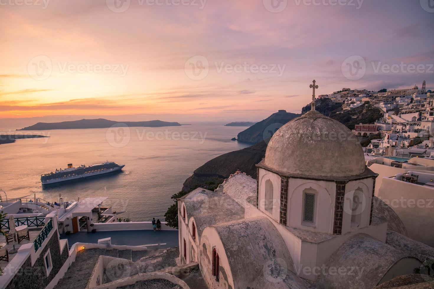 Great evening view of Santorini island. Picturesque spring sunset on the famous Greek resort Fira, Greece, Europe. Traveling concept background. Beautiful sunset landscape of famous vacation scenery photo