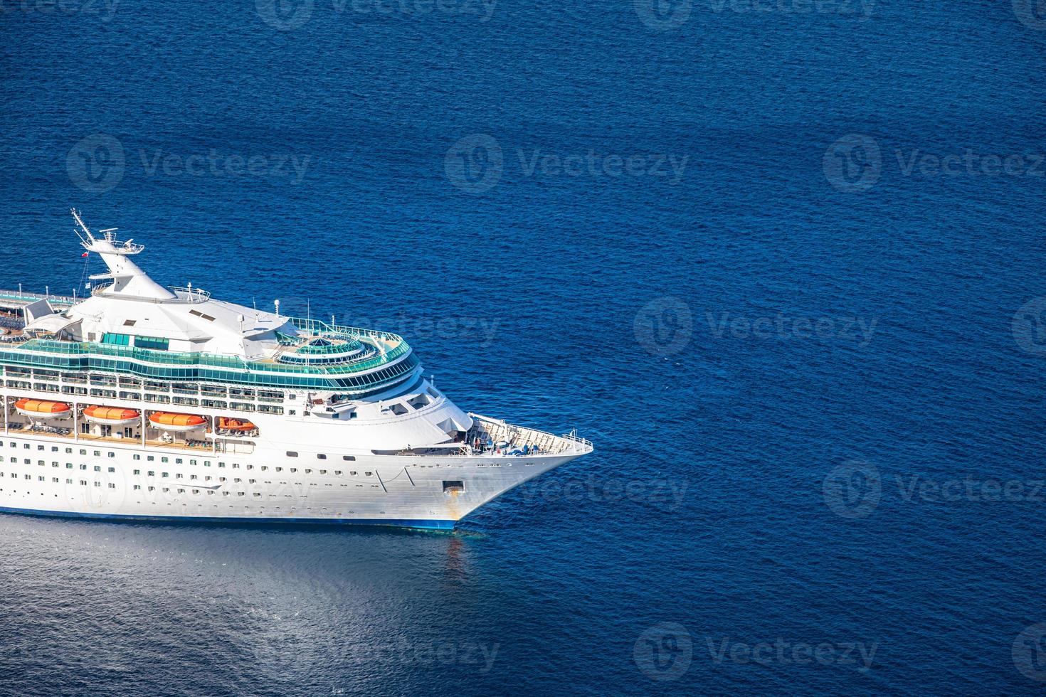 Front side view of cruise ship in deep blue sea. Transportation and sea travel concept, cruise line. Summer outdoor scene, vacation or holiday with ship transport. European sea travel concept photo