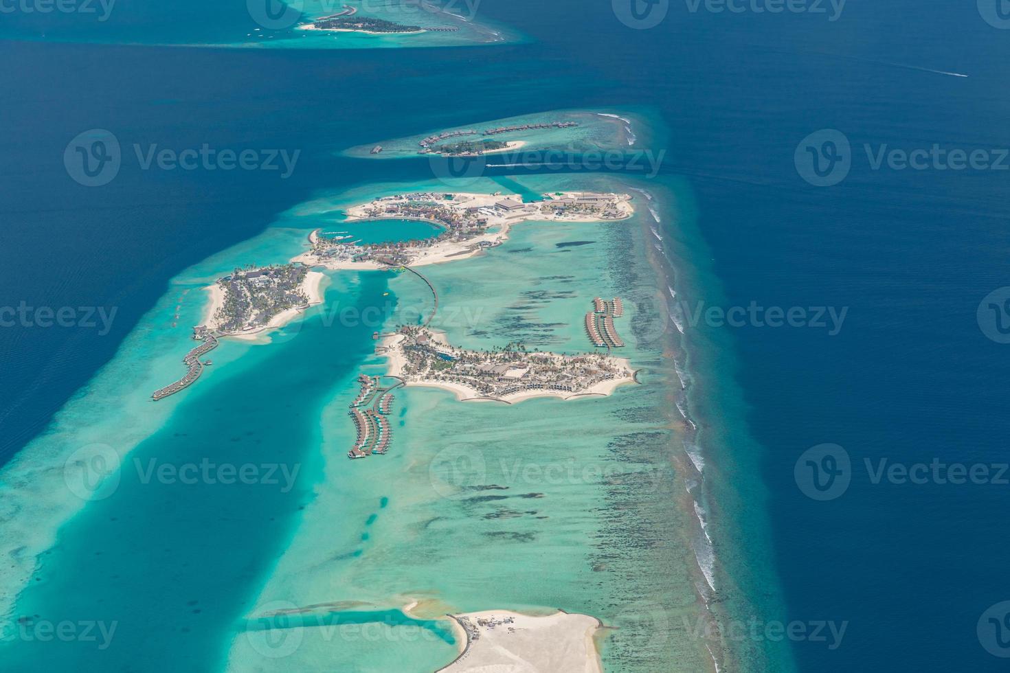 Aerial view of coral reefs in Maldives islands. Tropical aerial landscape. Luxury summer vacation and travel destination photo