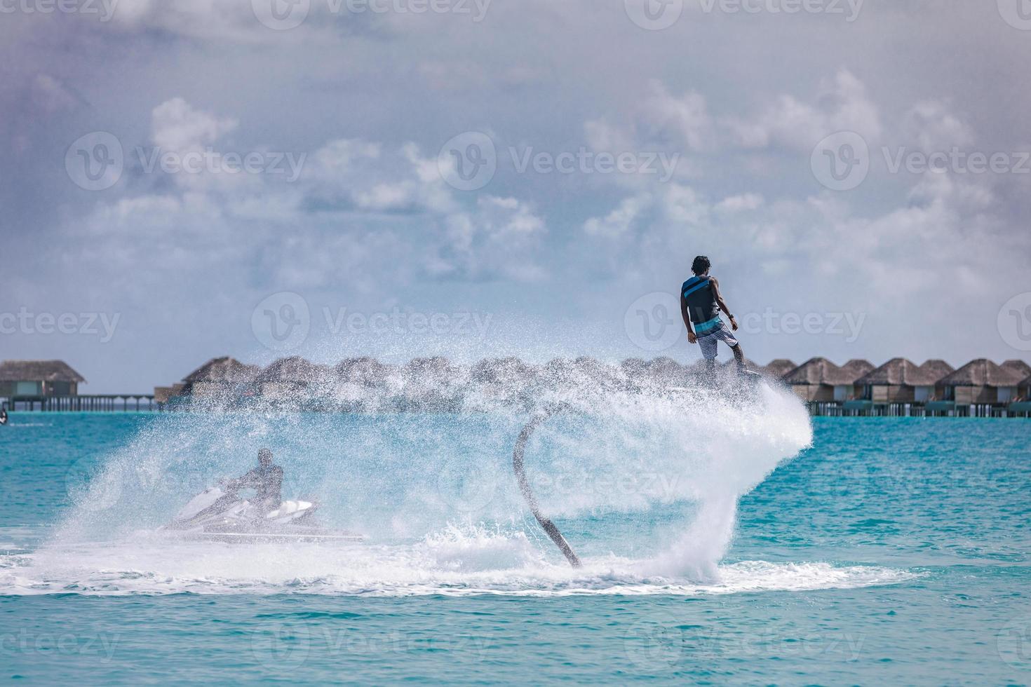 Professional pro fly board rider in tropical sea, water sports concept background. Summer vacation fun outdoor sport and recreation photo