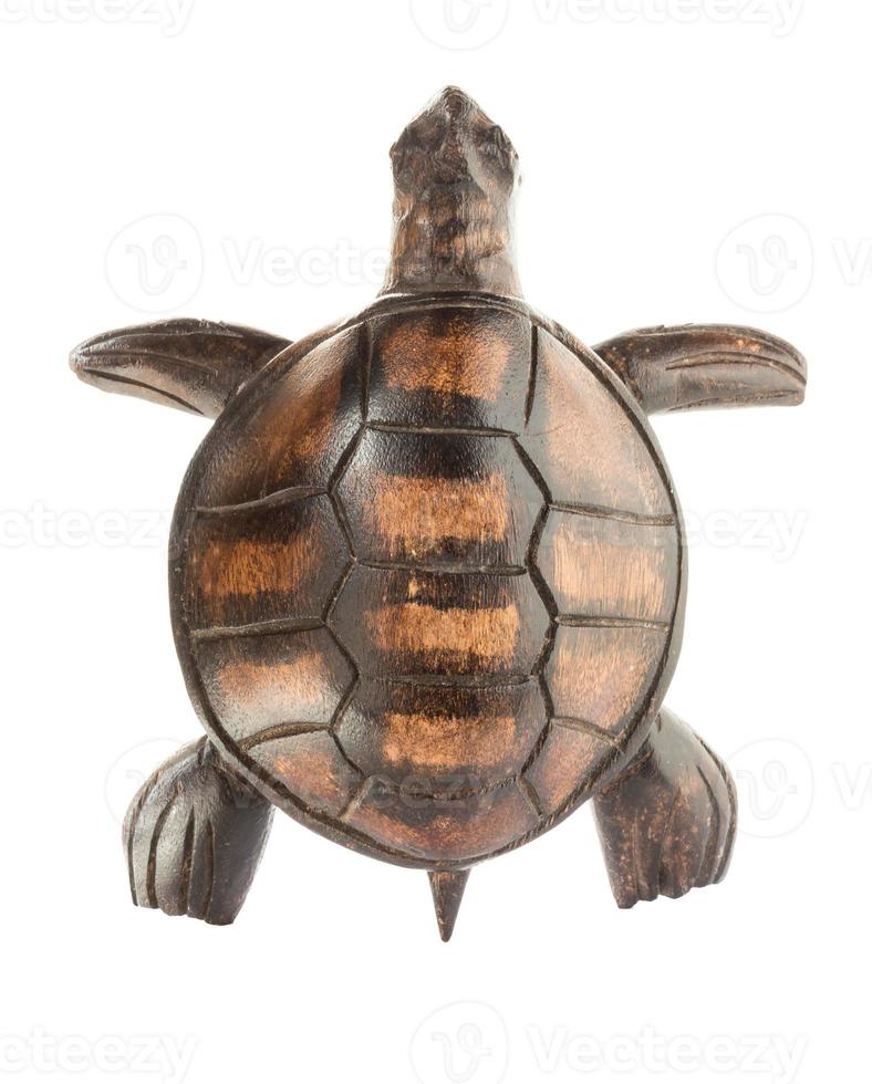 Wooden figurine of a sea turtle isolated on a white background. View from above. photo