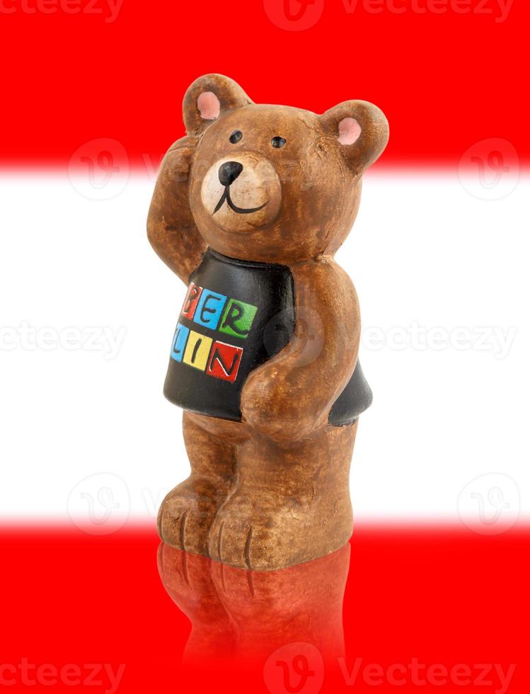 The bear is the symbol of the city of Berlin. Bear on the background of the flag of the city of Berlin. photo