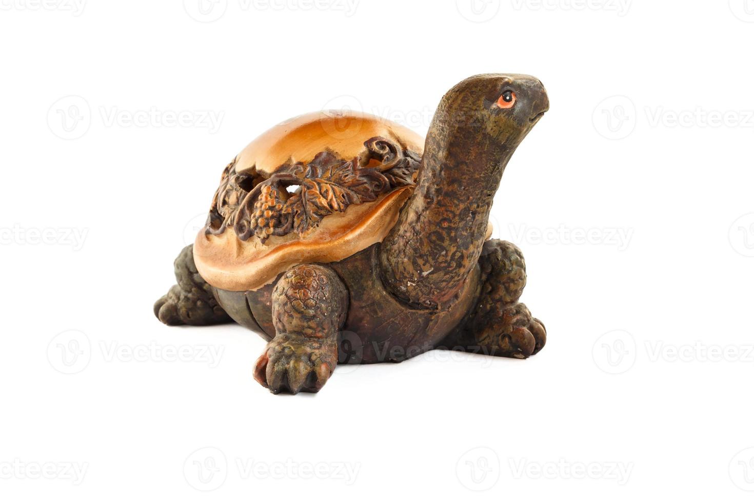 Wooden turtle figurine isolated on white background. Figurine of a turtle carved from wood. photo