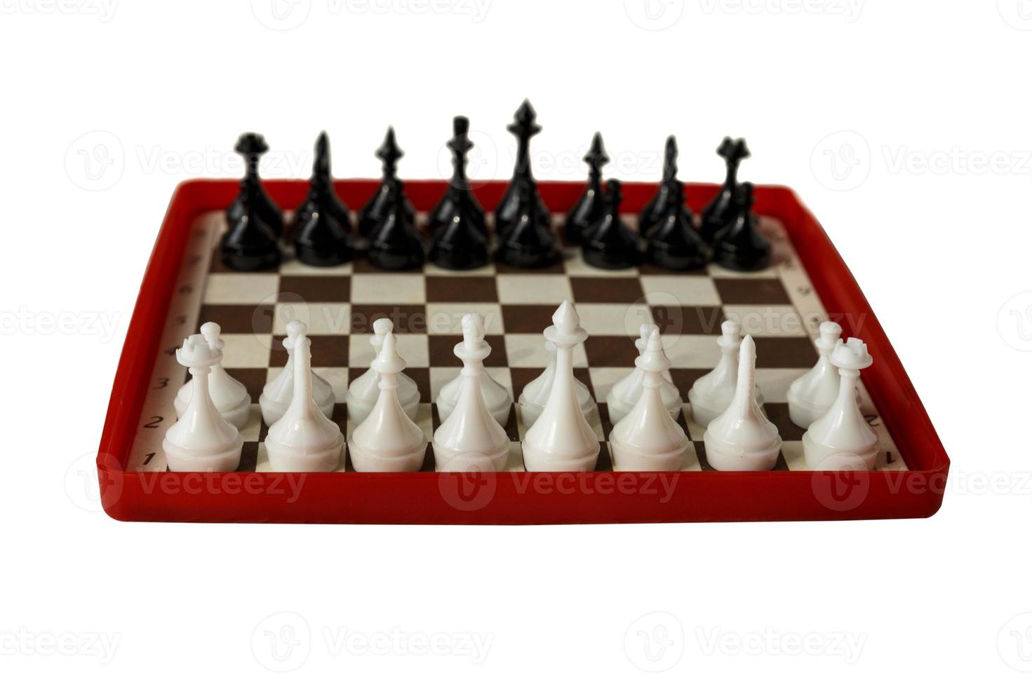 plastic chess board isolated on a white background. Travel chess. Selective focus. photo
