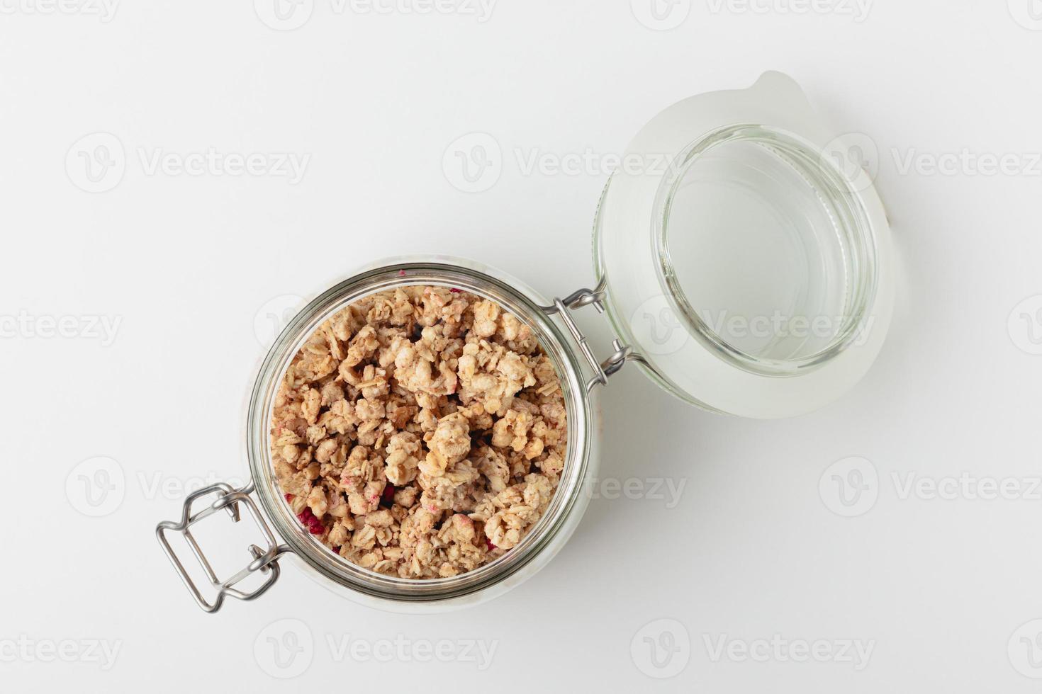 Granola in jar on light background. photo