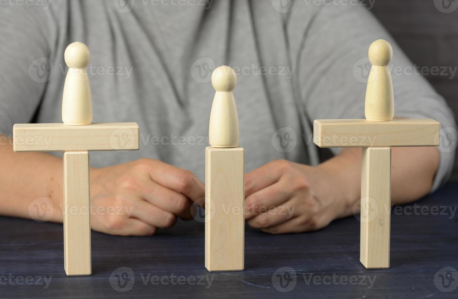 wooden figures stand on the bridge from the sides opposite each other photo