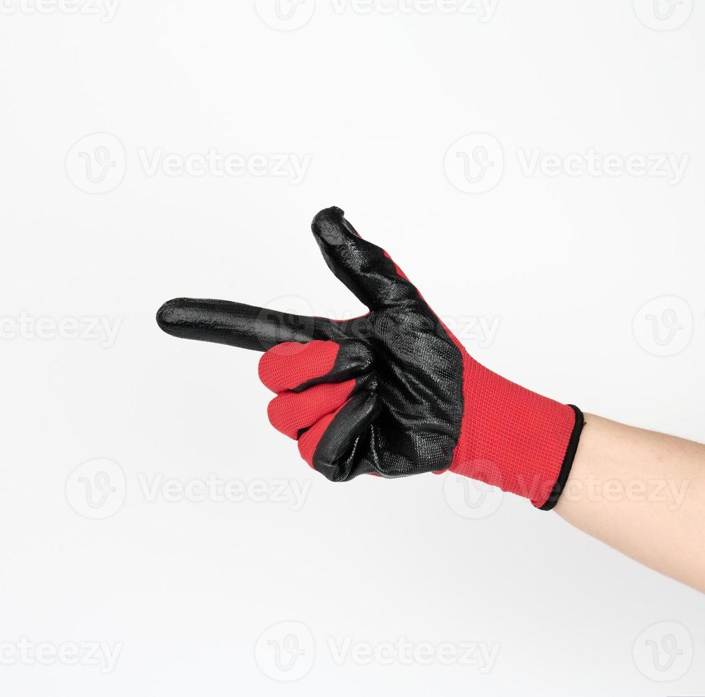 hand in a black-red textile work glove points with the index finger to the side on white photo