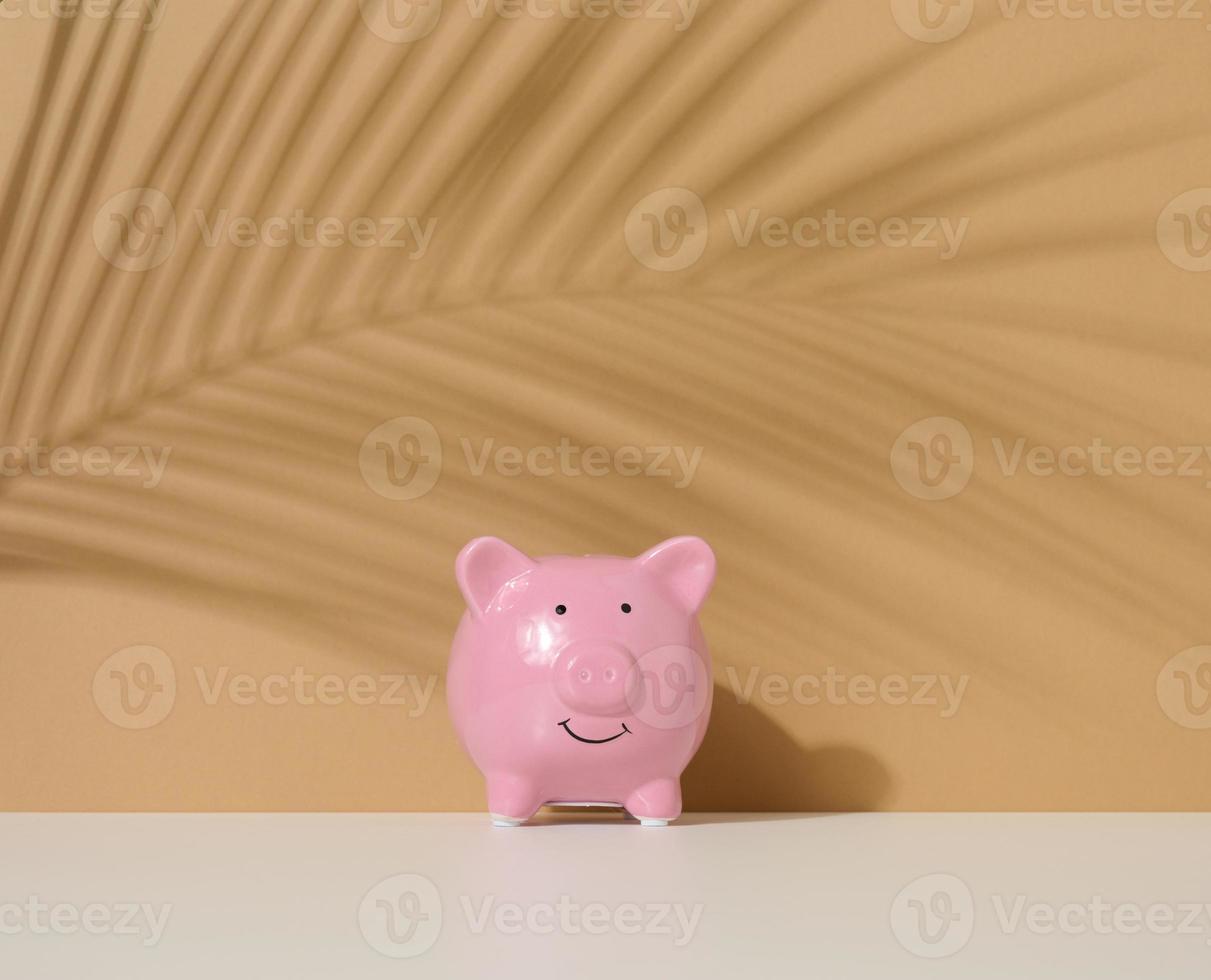 ceramic pink piggy bank on a brown background. Concept of increasing income from bank accounts, savings photo