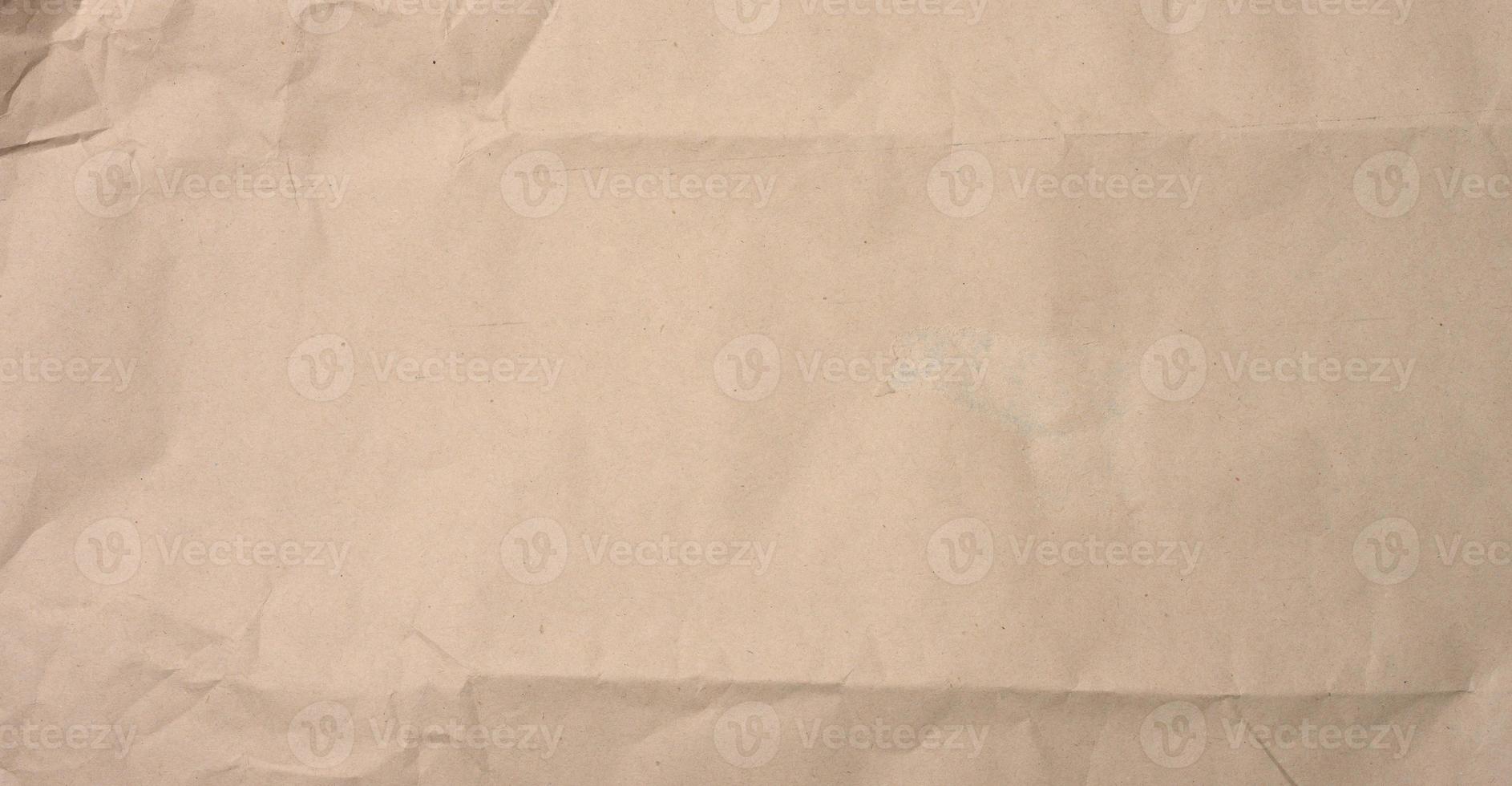 crumpled blank sheet of brown wrapping kraft paper photo