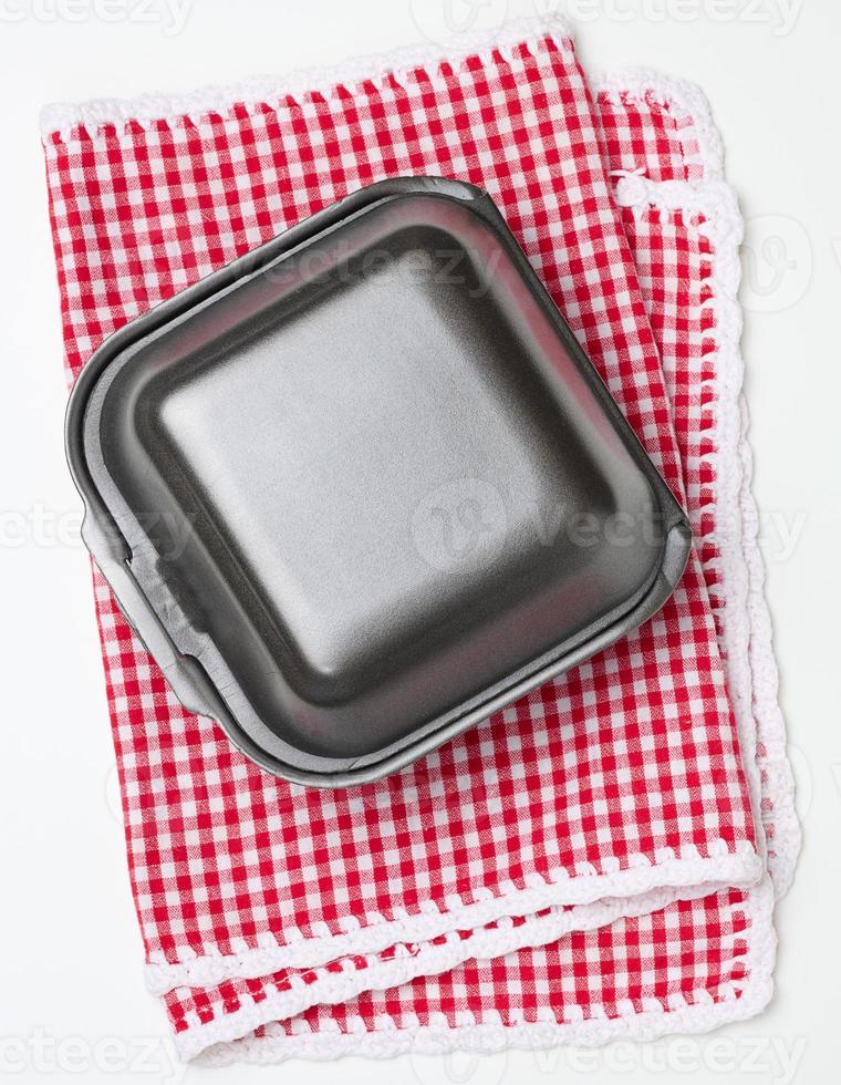 Disposable food container. Gray box of polystyrene on a white background photo