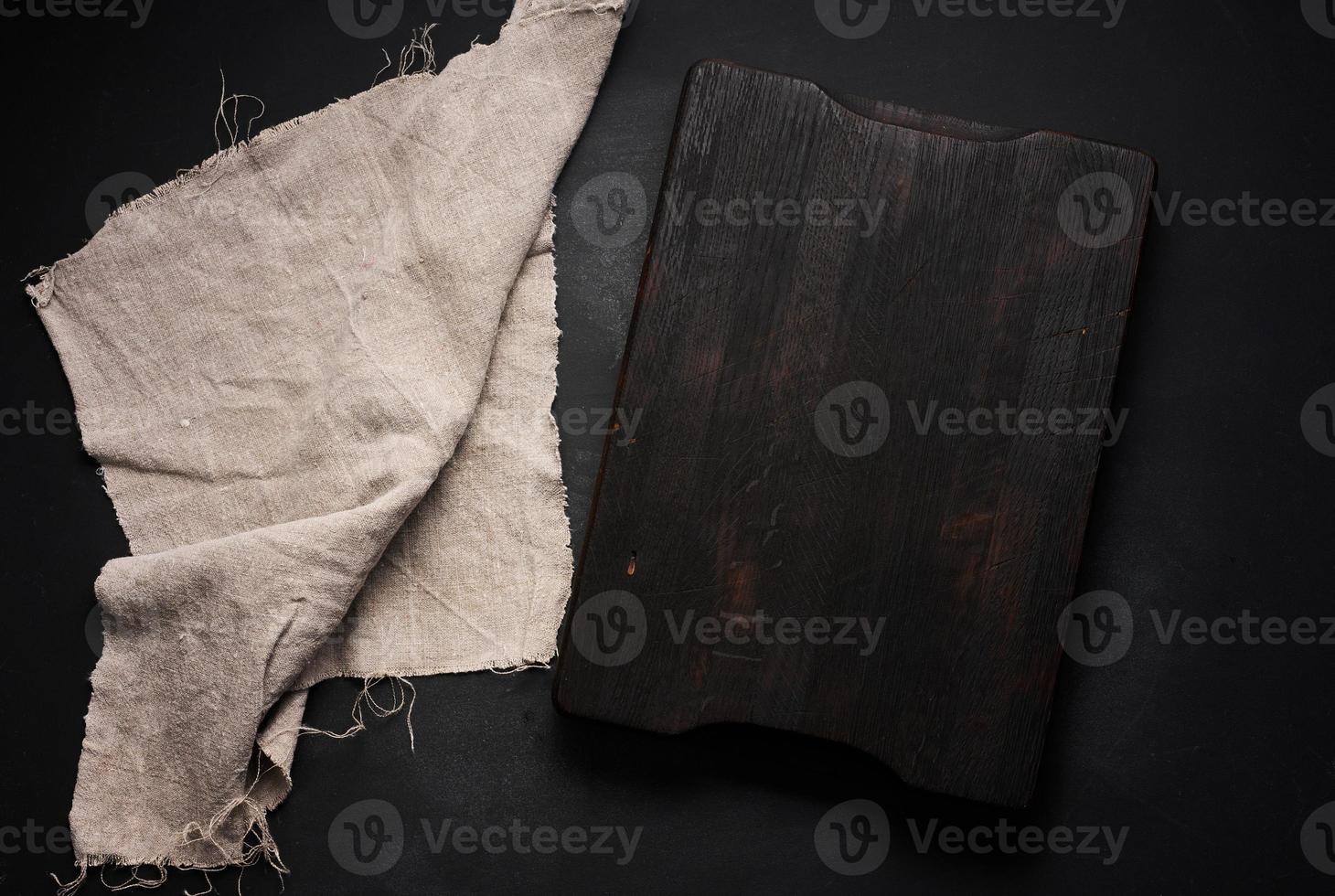 empty wooden square cutting board on black table, food display template, top view photo