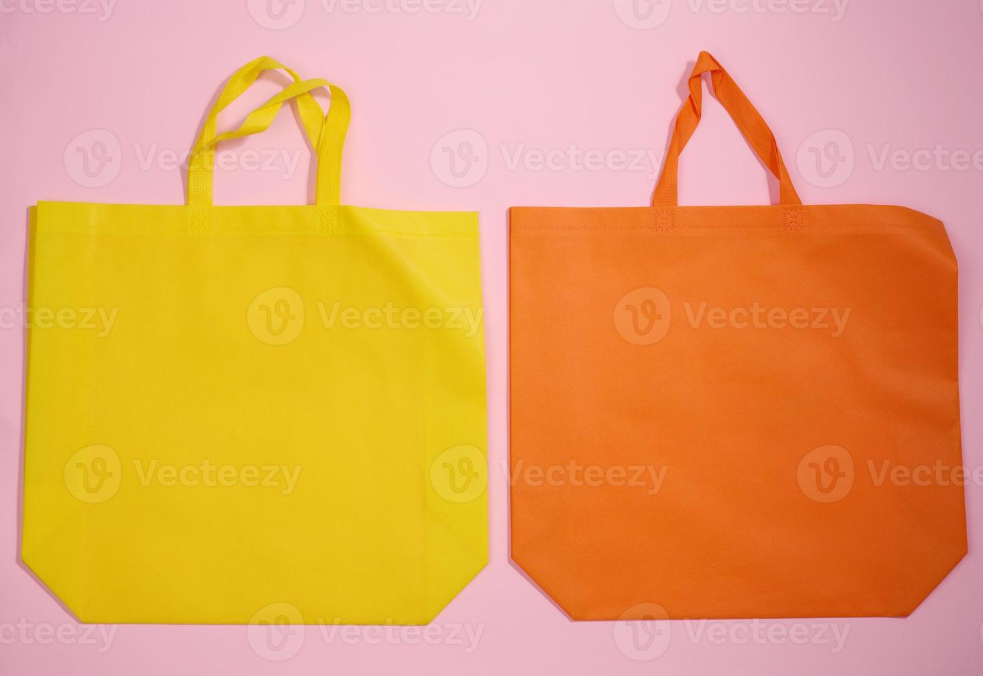 empty viscose eco friendly canvas tote bag for branding on a pink background. Clear reusable bag for groceries, mock up. Flat lay photo