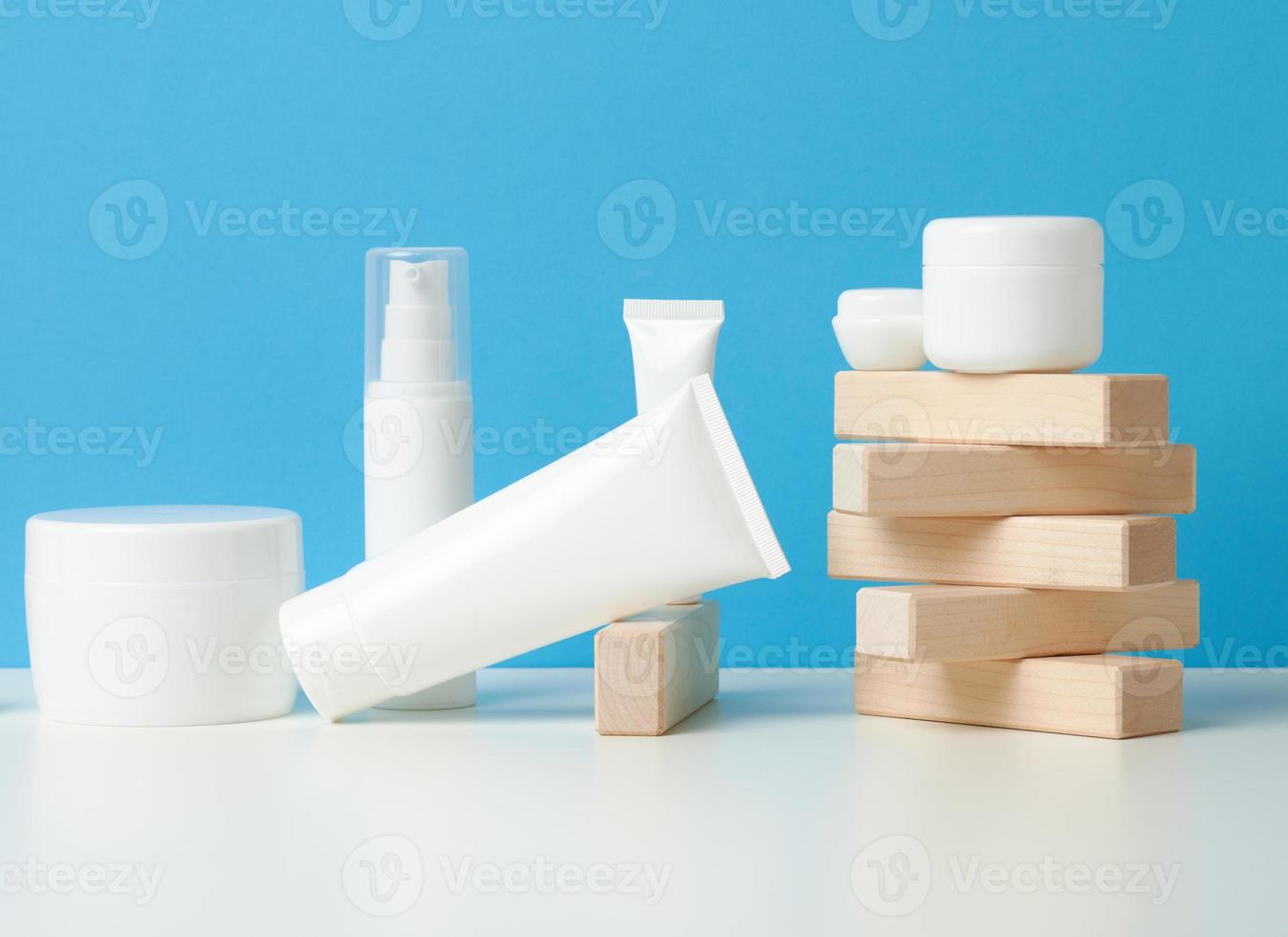 bottle and empty white plastic tubes for cosmetics on a white background. Packaging for cream, gel, serum, advertising and product promotion photo