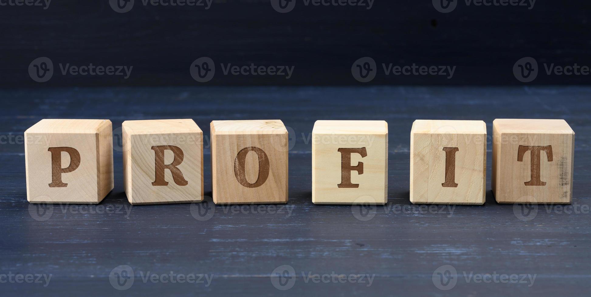 wooden cubes with the inscription profit. Profit making concept, business growth, easy money. photo