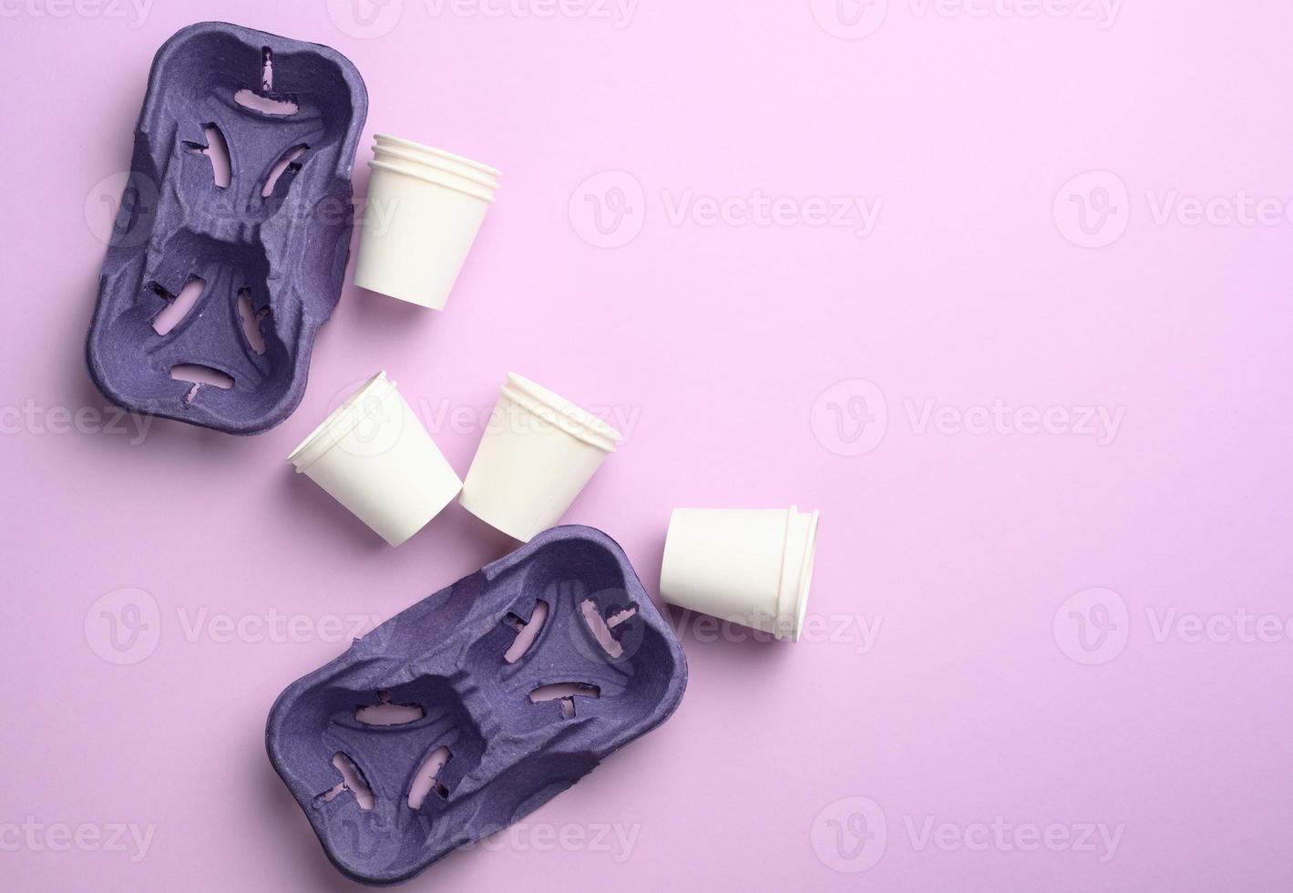 purple recycled paper cup holders and white paper cups, top view photo