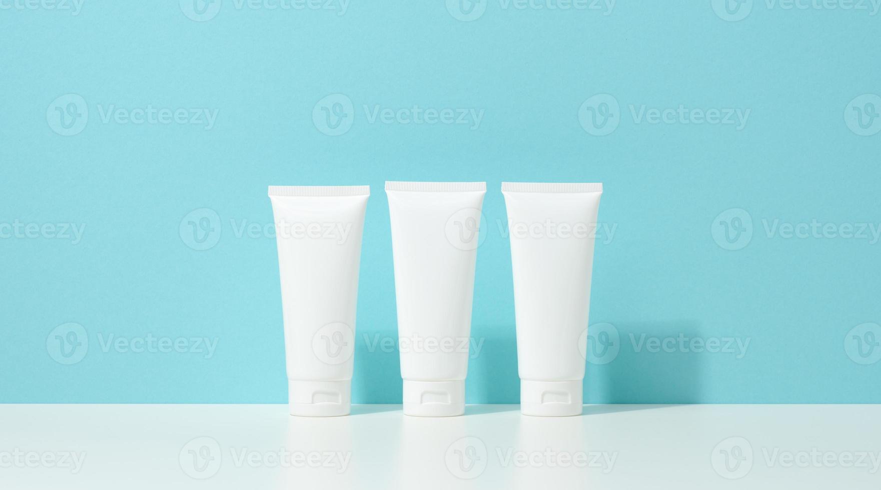 empty white plastic tubes for cosmetics. Packaging for cream, gel, serum, advertising and product promotion, mock up photo