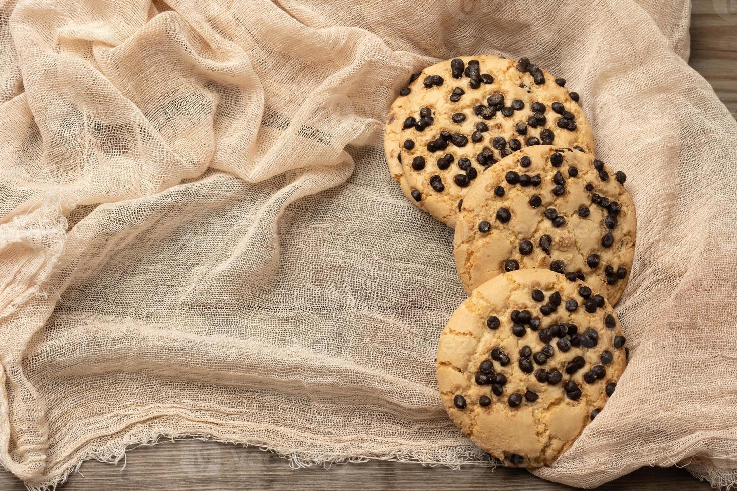 round cookies with pieces of chocolate on a textile towel photo