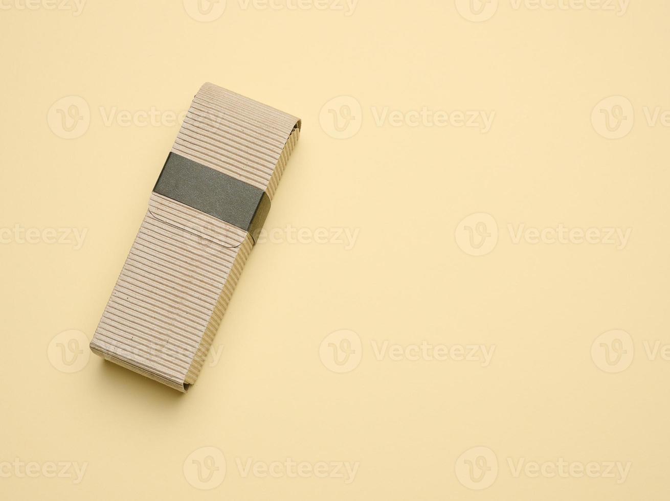 Rectangular brown corrugated box for packing goods, perfumes, creams and cosmetics photo