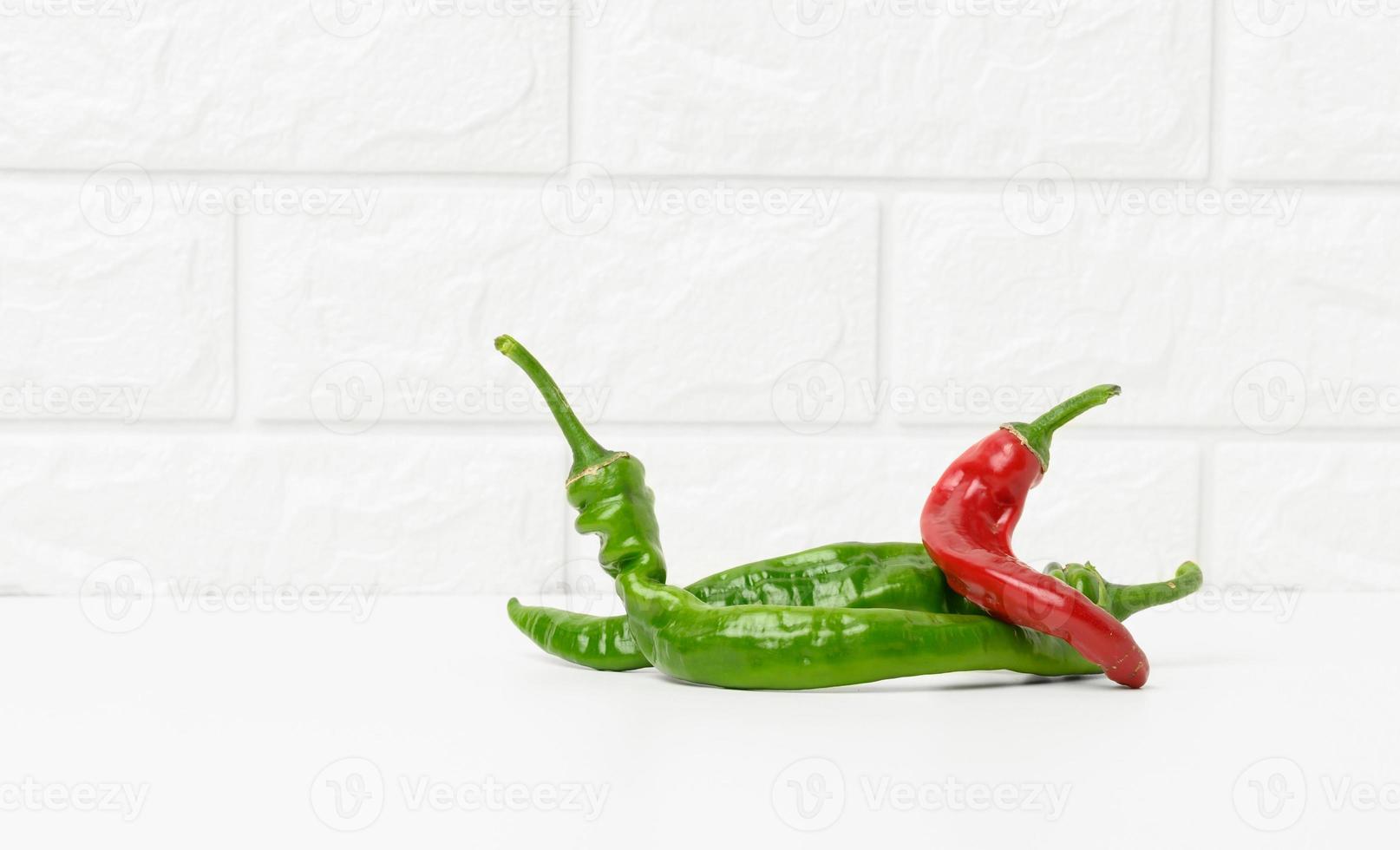 fresh pods of hot pepper on a white background. photo