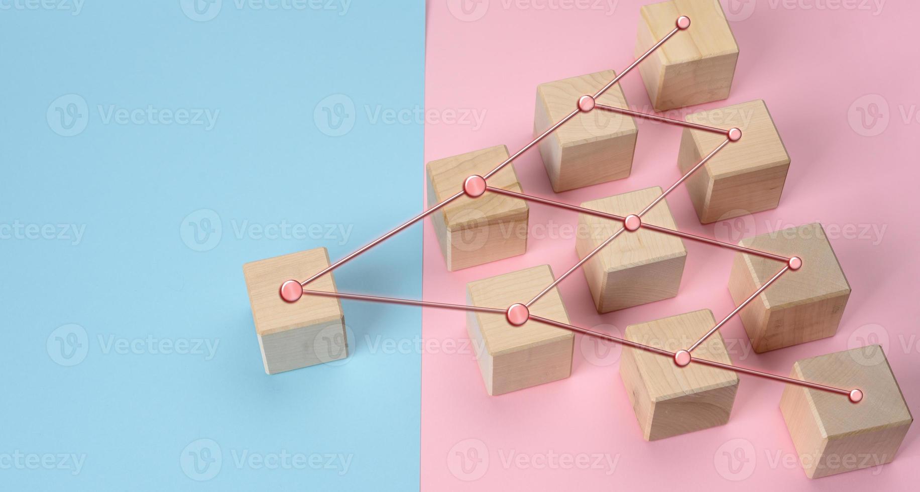 wooden blocks on a pink blue background, hierarchical organizational structure of management photo