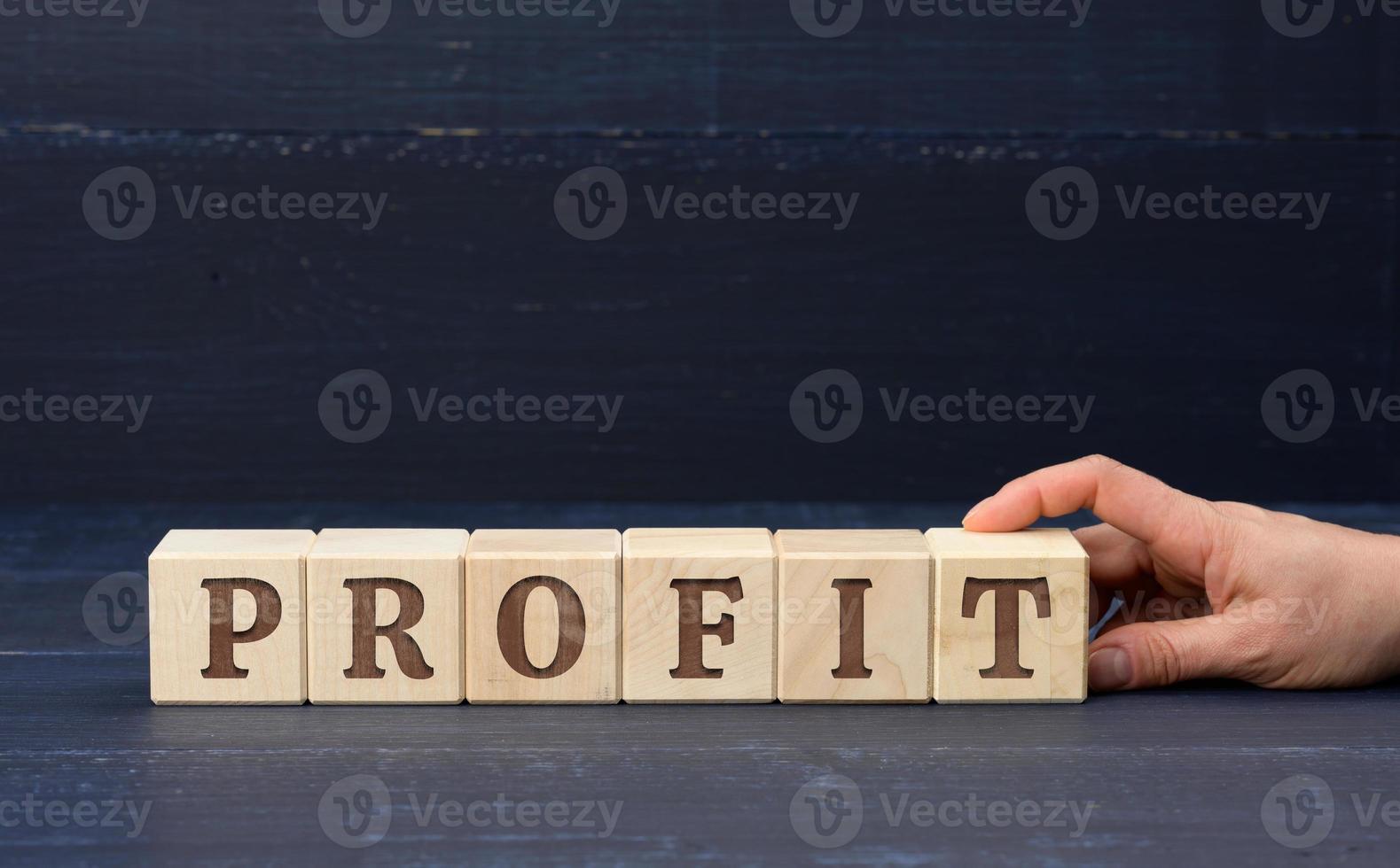 wooden cubes with the inscription profit. Profit making concept, business growth, easy money photo