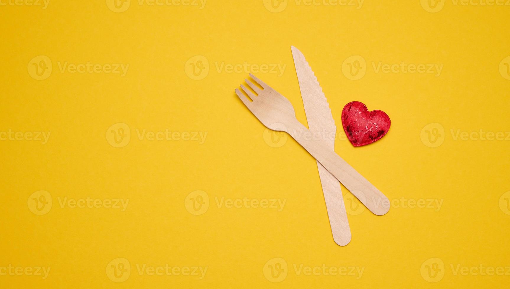 disposable fork and knife on a yellow background, eco utensils. Zero Waste photo