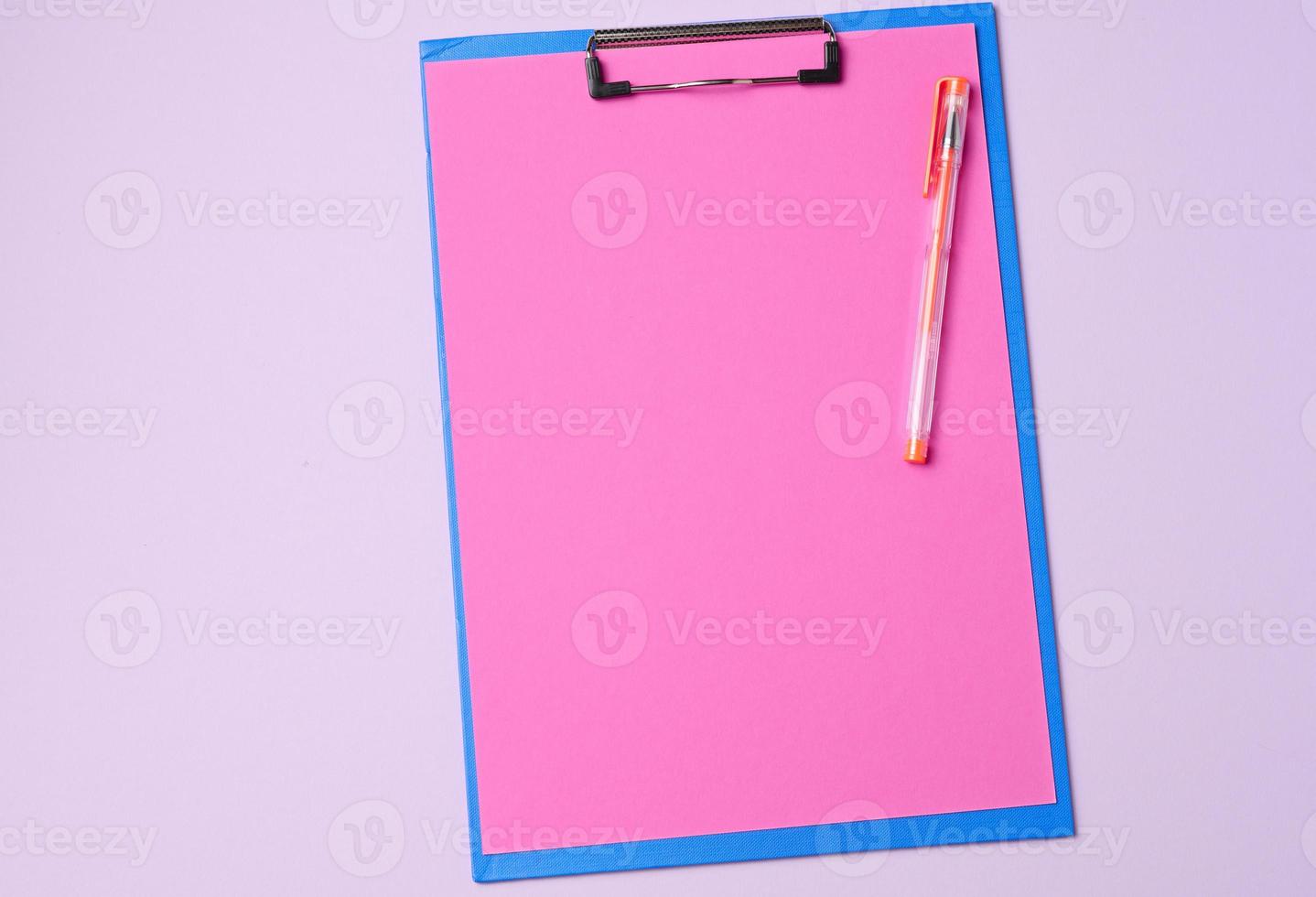 blue holder with clean pink sheets on a purple background, top view photo