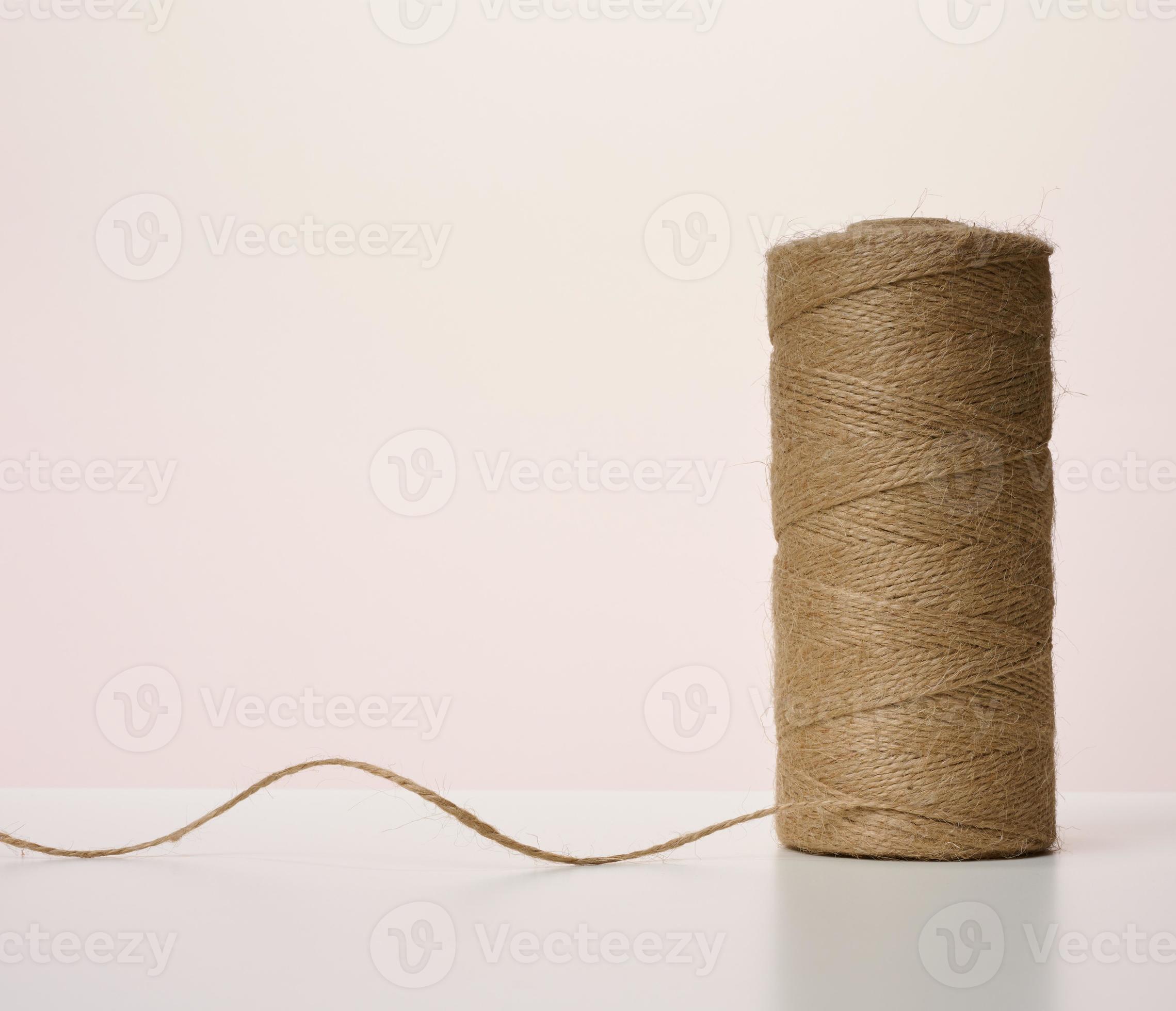 Skein of green and brown thread on a beige background Stock Photo by ndanko