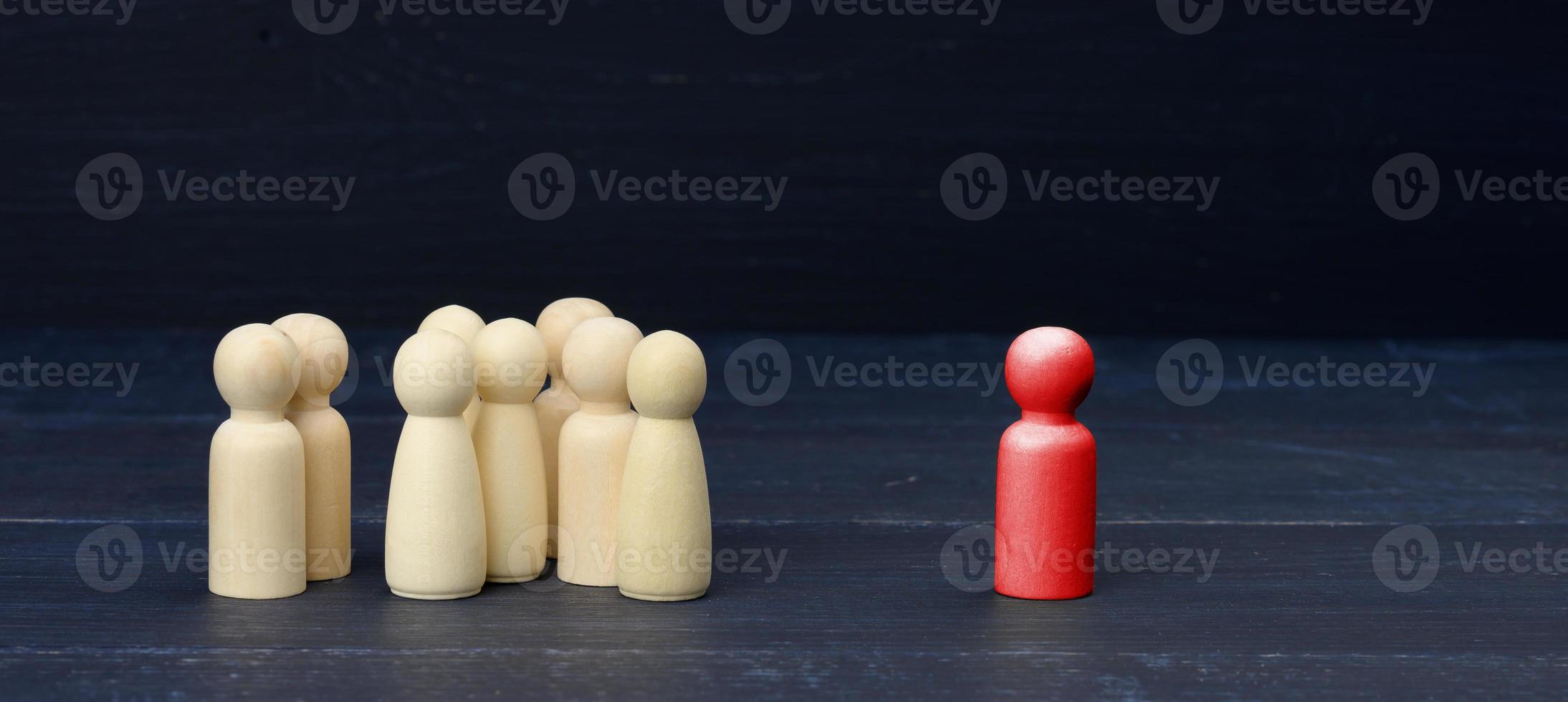 red figurine of a man among the crowd on a blue background. The concept of searching for employees, talented people photo