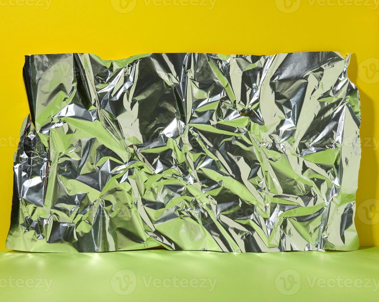 abstract background for product demonstration, crumpled foil with green reflection, blank photo