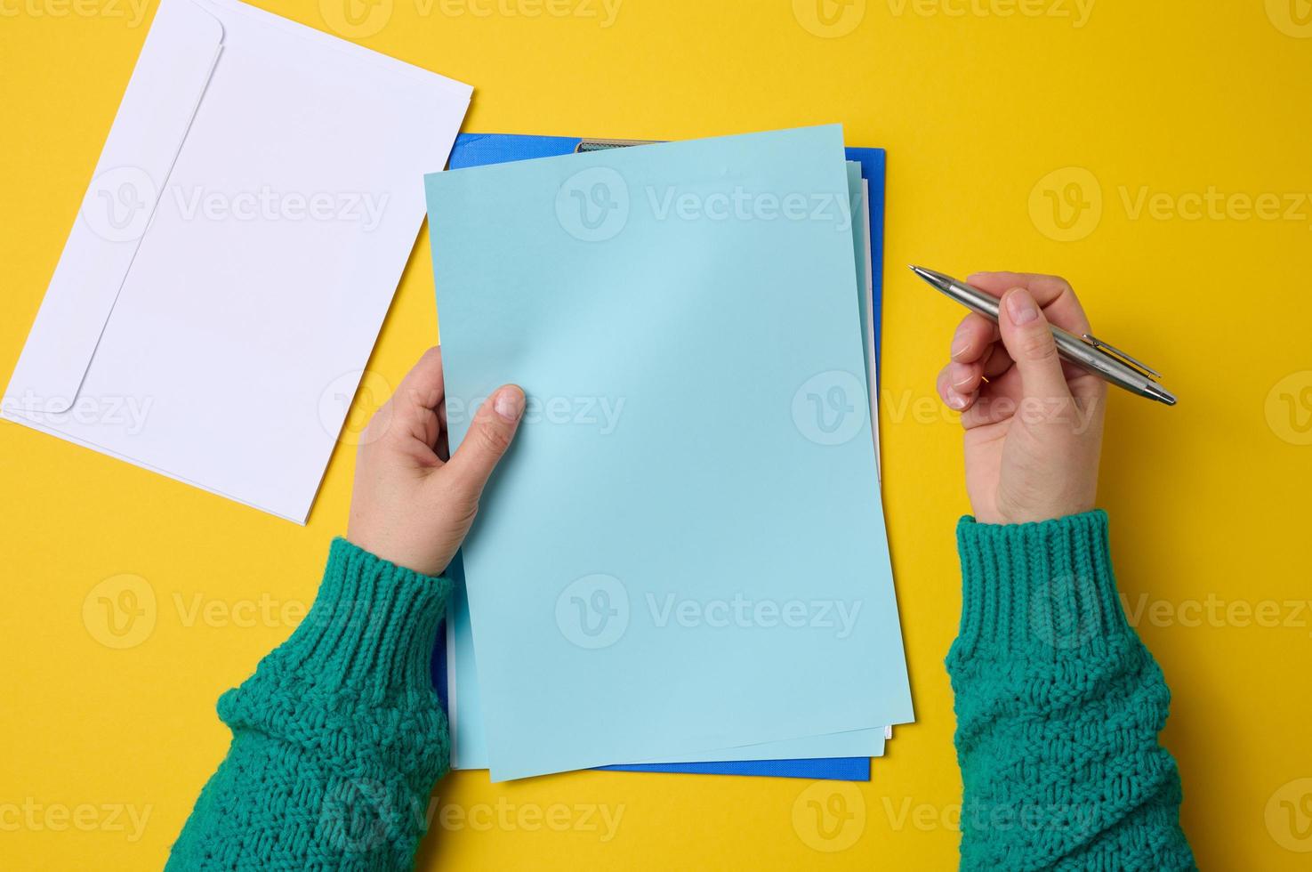 blank white sheets and two female hands, top view. Text writing, list photo