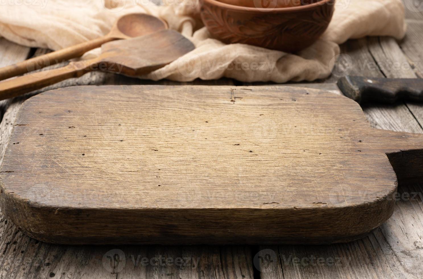 very okd empty rectangular wooden cutting kitchen board on table photo