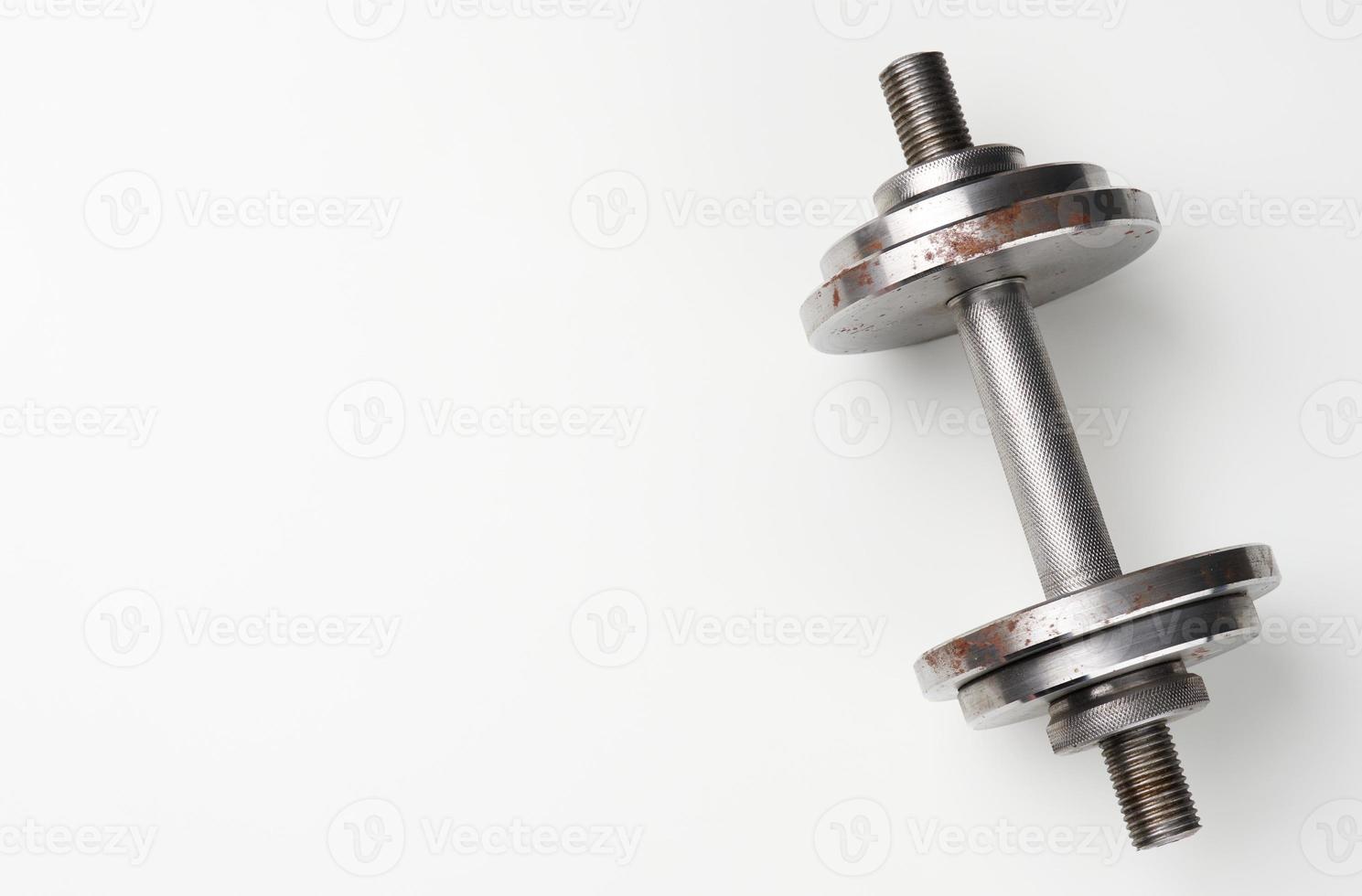 metal dumbbell with typesetting circles on a white background, sports equipment photo