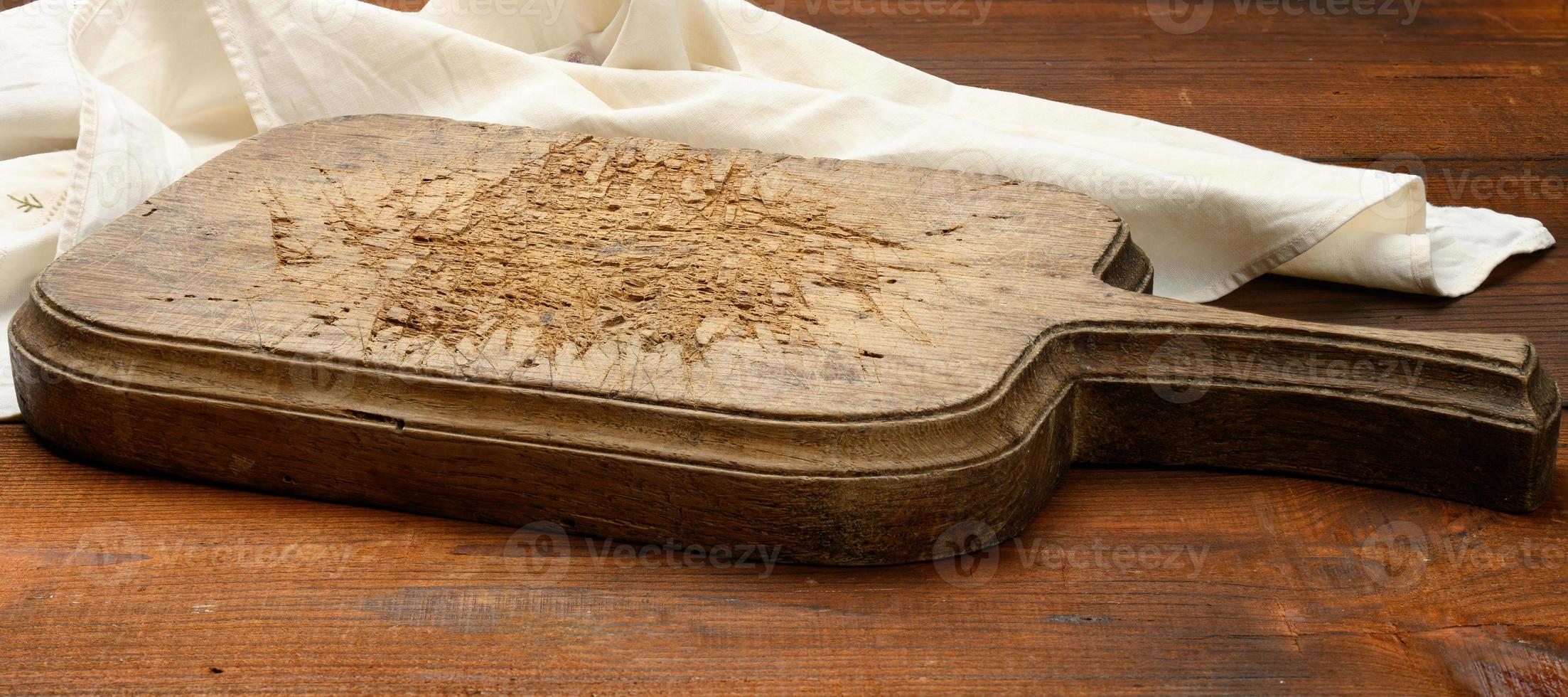 empty rectangular wooden cutting kitchen board on table, top view photo